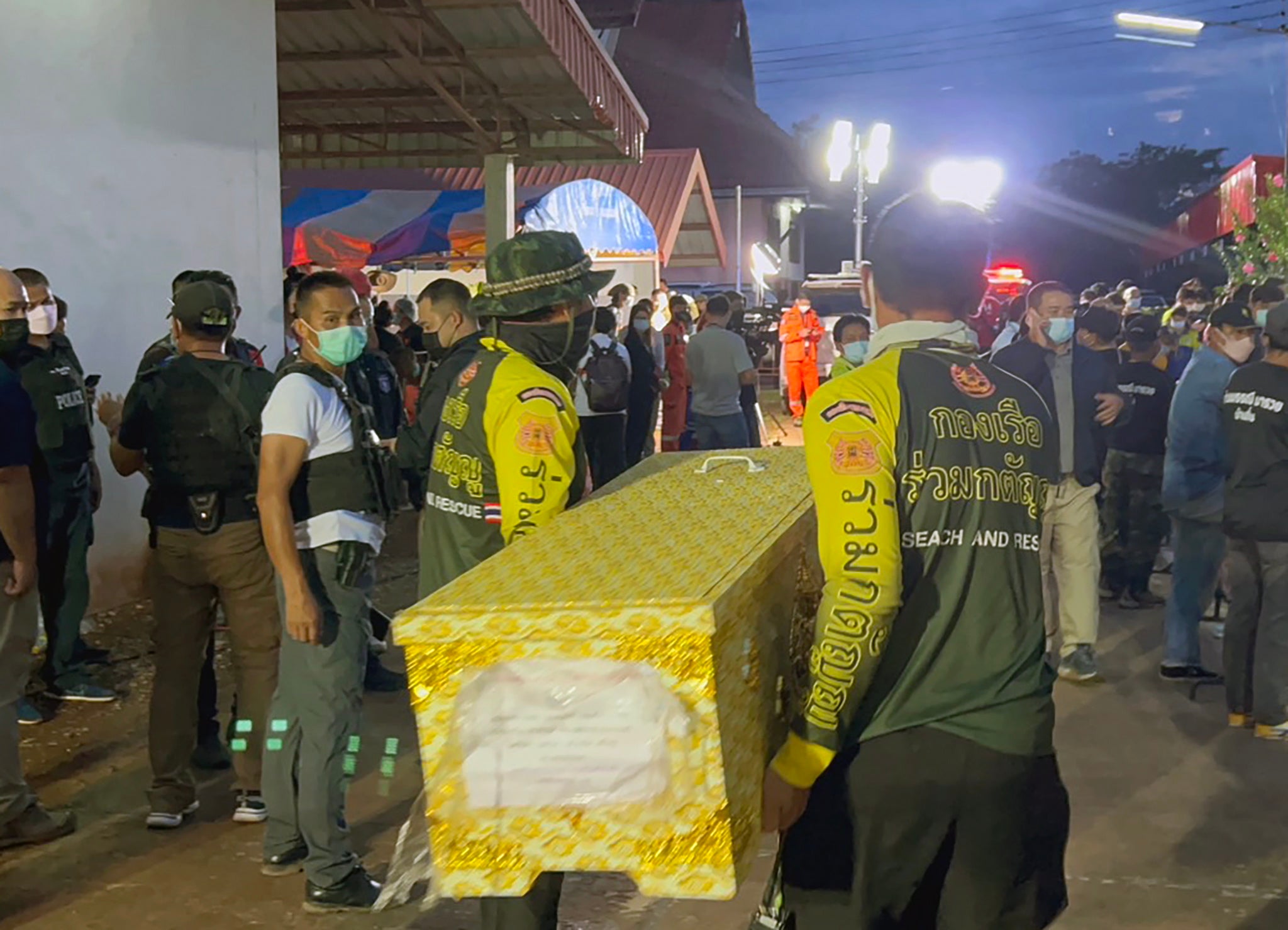 Thai rescue workers carry a coffin containing from the daycare centre in Nong Bua Lamphu