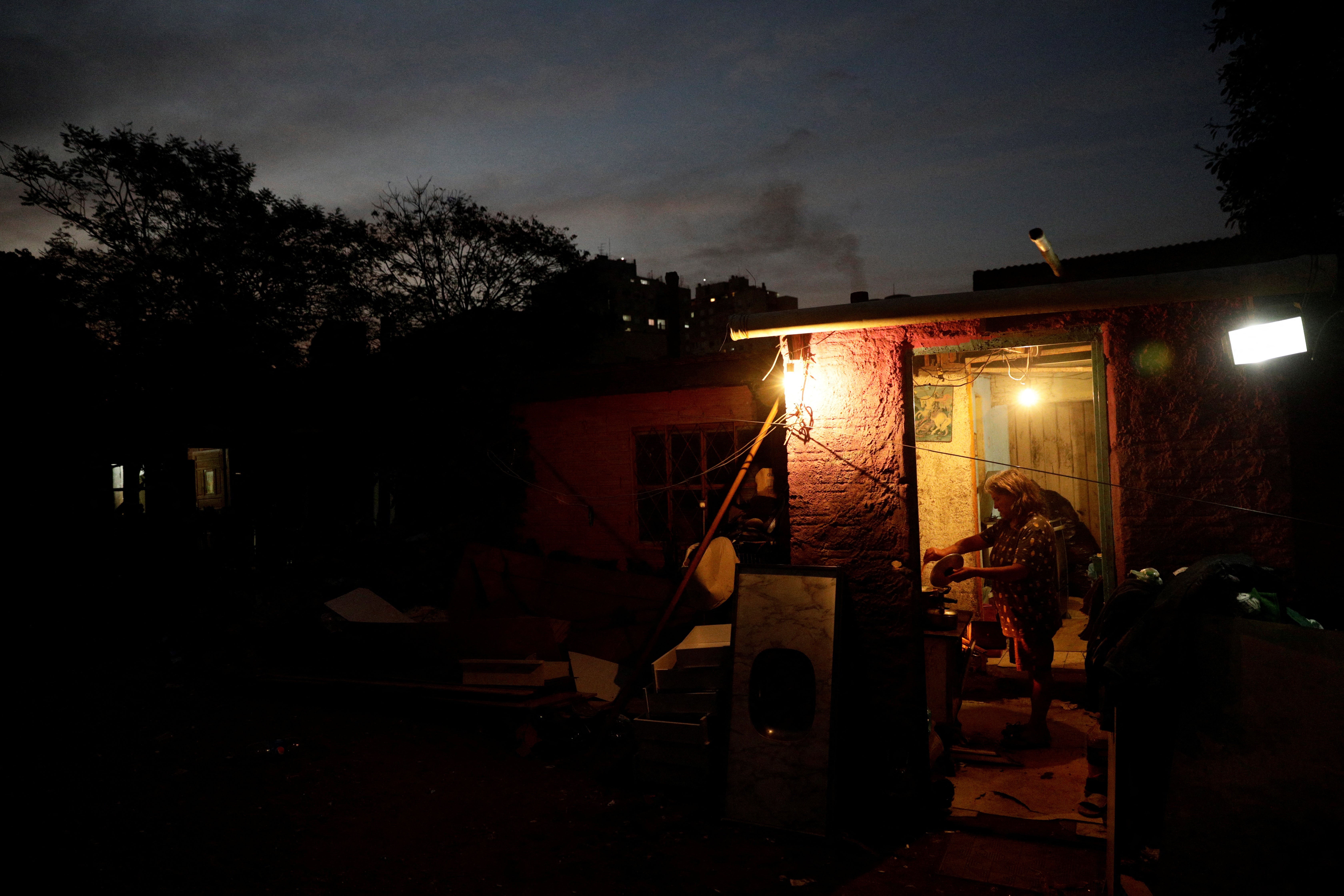 Elvira de Fatima Saraiva, 57, prepares dinner, the family's only meal of the day, in Porto Alegre