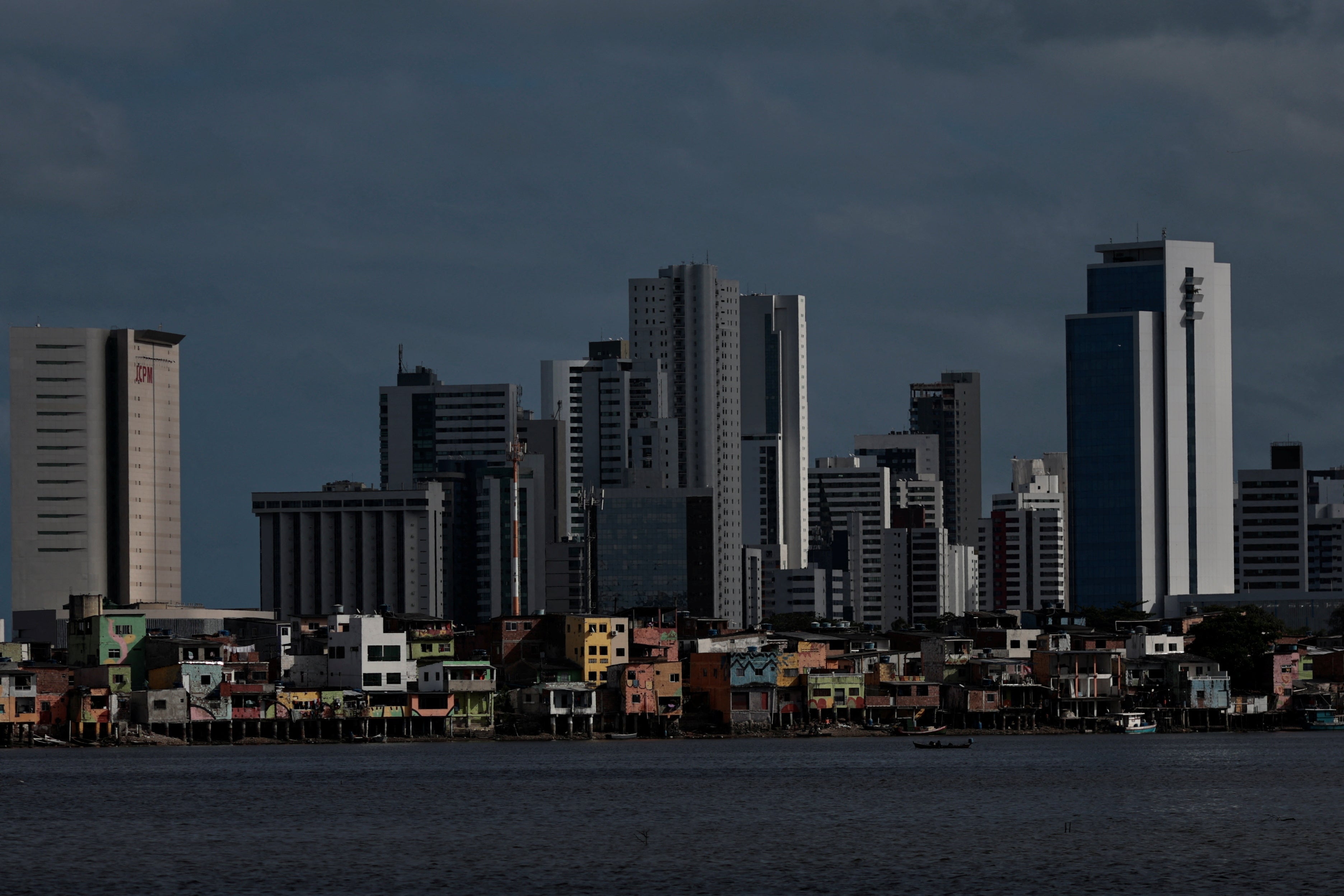 A view of the Brasilia Teimosa favela is seen beneath the residential buildings of the Boa Viagem neighbourhood in Recife