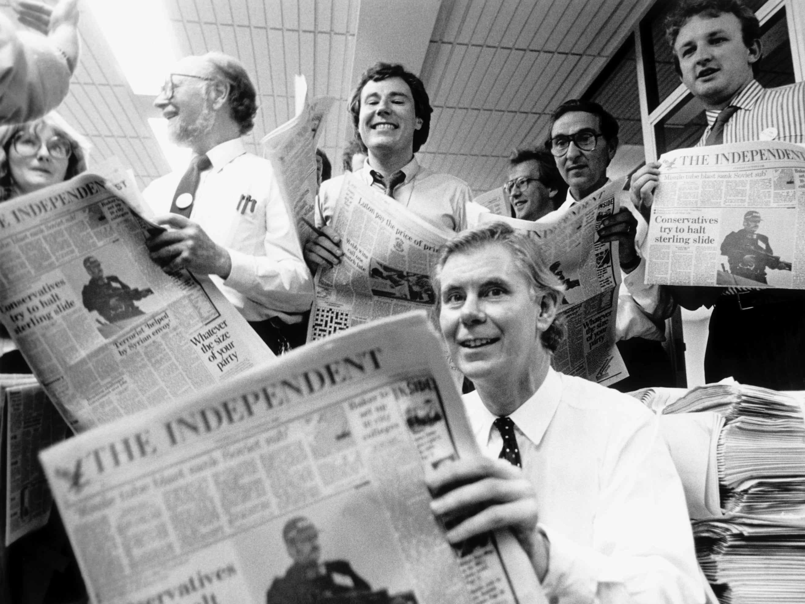 Andreas Whittam Smith holding a copy of the first official The Independent newspaper