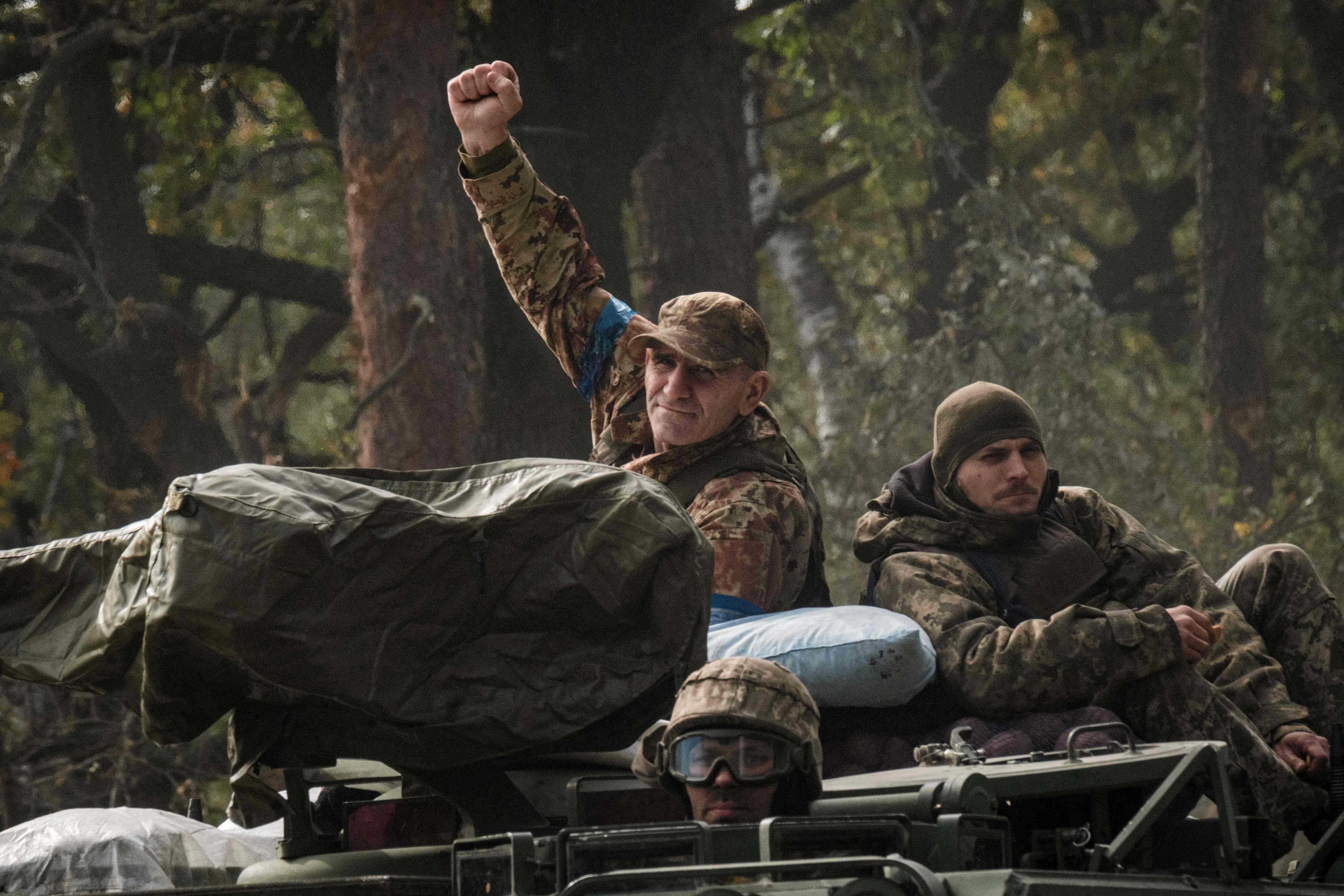 A Ukrainian soldier on an armoured vehicle near the recently liberated town of Lyman in Donetsk on Thursday