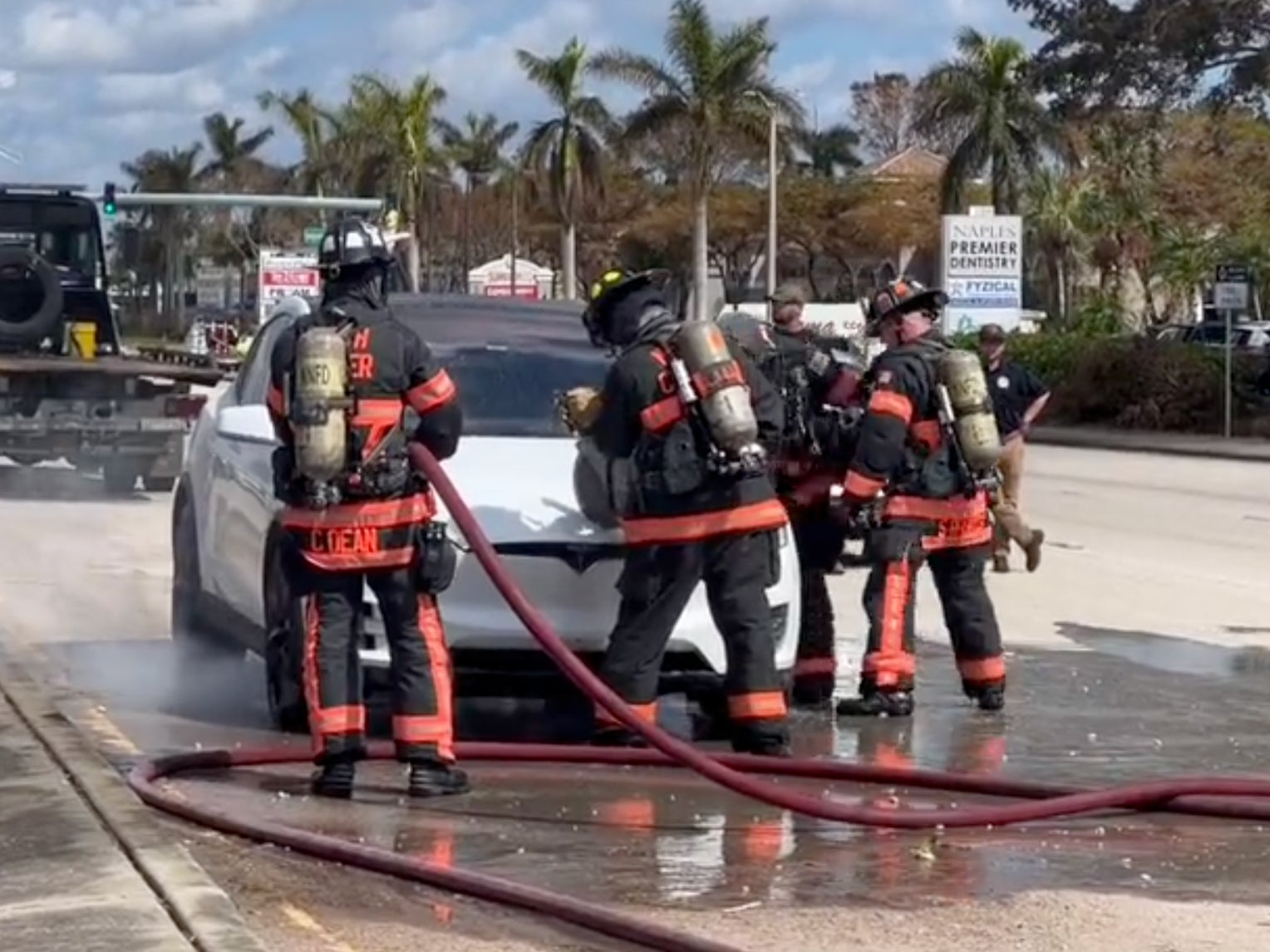 Firefighters in Florida attempt to put out a Tesla fire prompted by Hurricane Ian