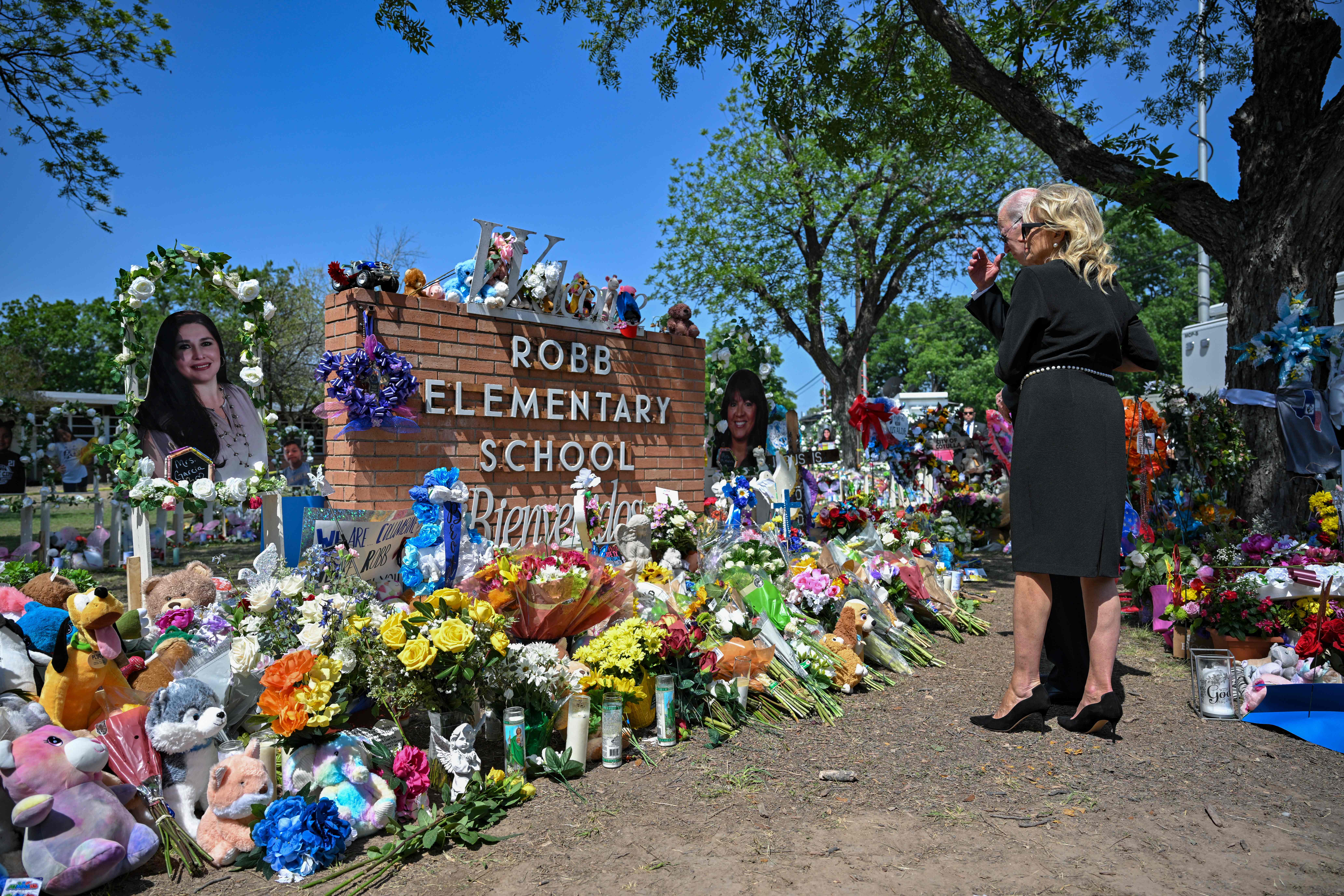 US President Joe Biden and First Lady Jill Biden pay their respects at a makeshift memorial outside of Robb Elementary School