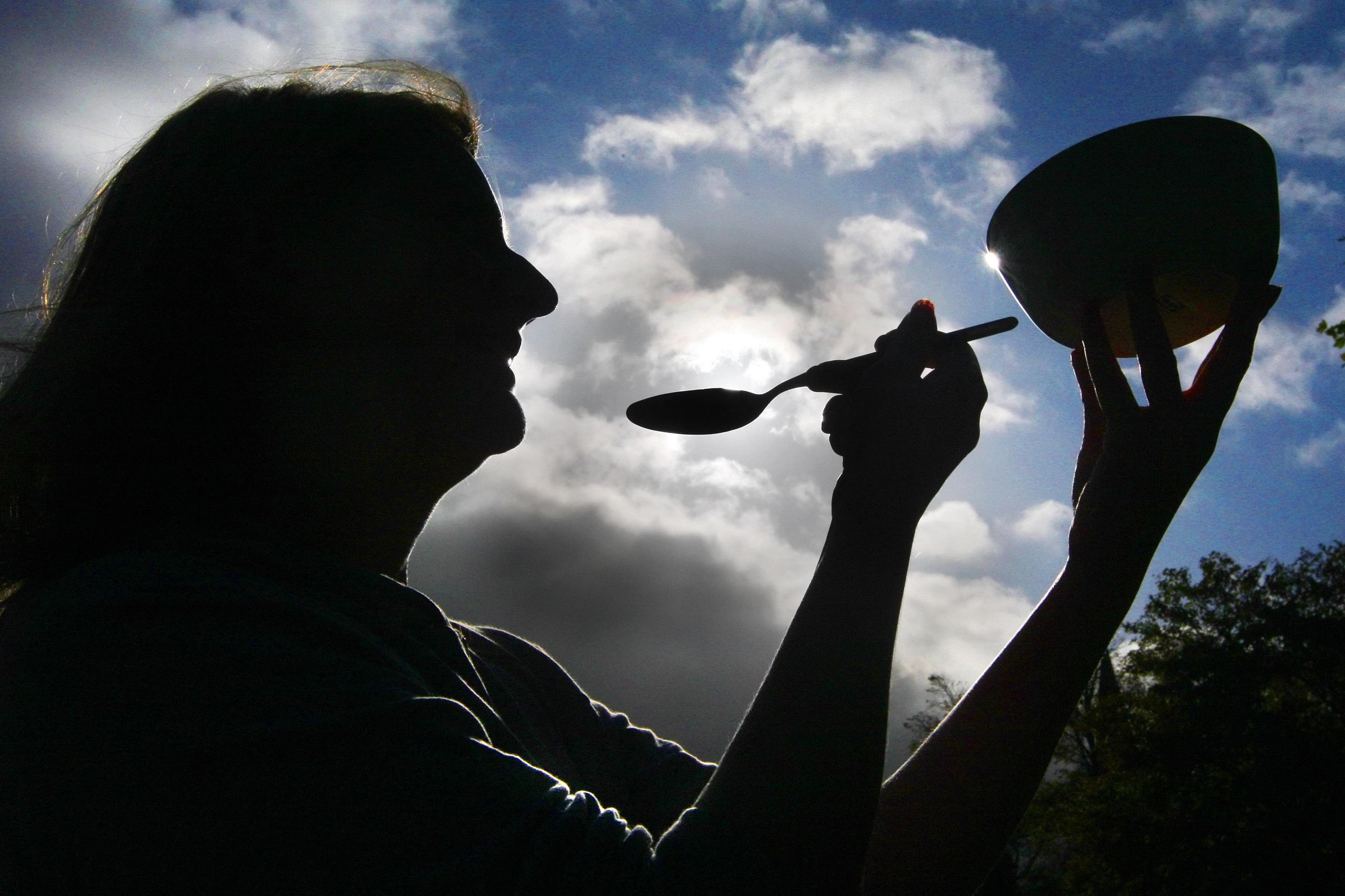 A woman eating a bowl of porridge to illustrate World Porridge Day (Danny Lawson/PA)