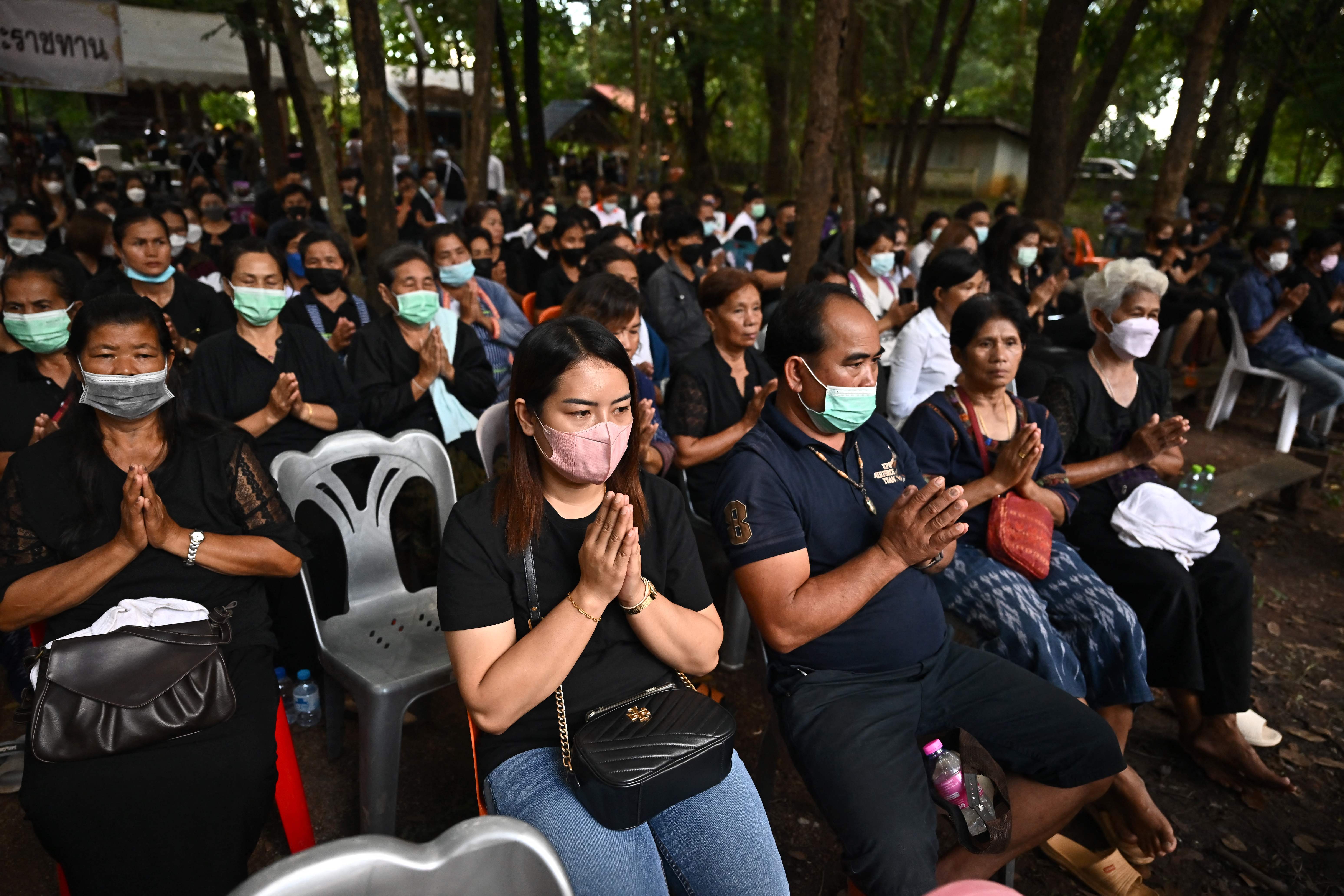 Members of the community take part in Buddhist prayers