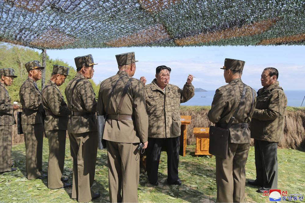 Kim Jong Un inspects military exercises at an undisclosed location