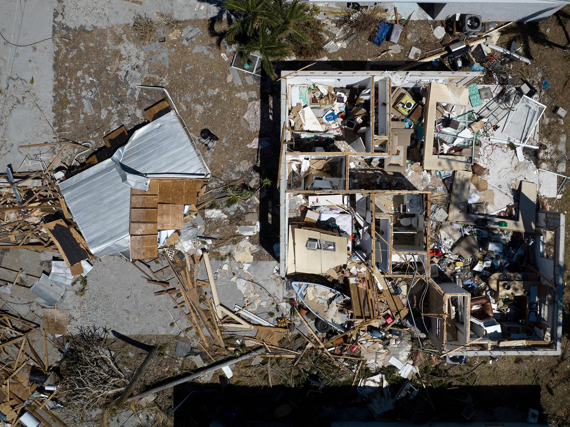An aerial picture taken on 3 October, 2022 shows a destroyed house in the aftermath of Hurricane Ian in West Inland, Matlacha, Florida