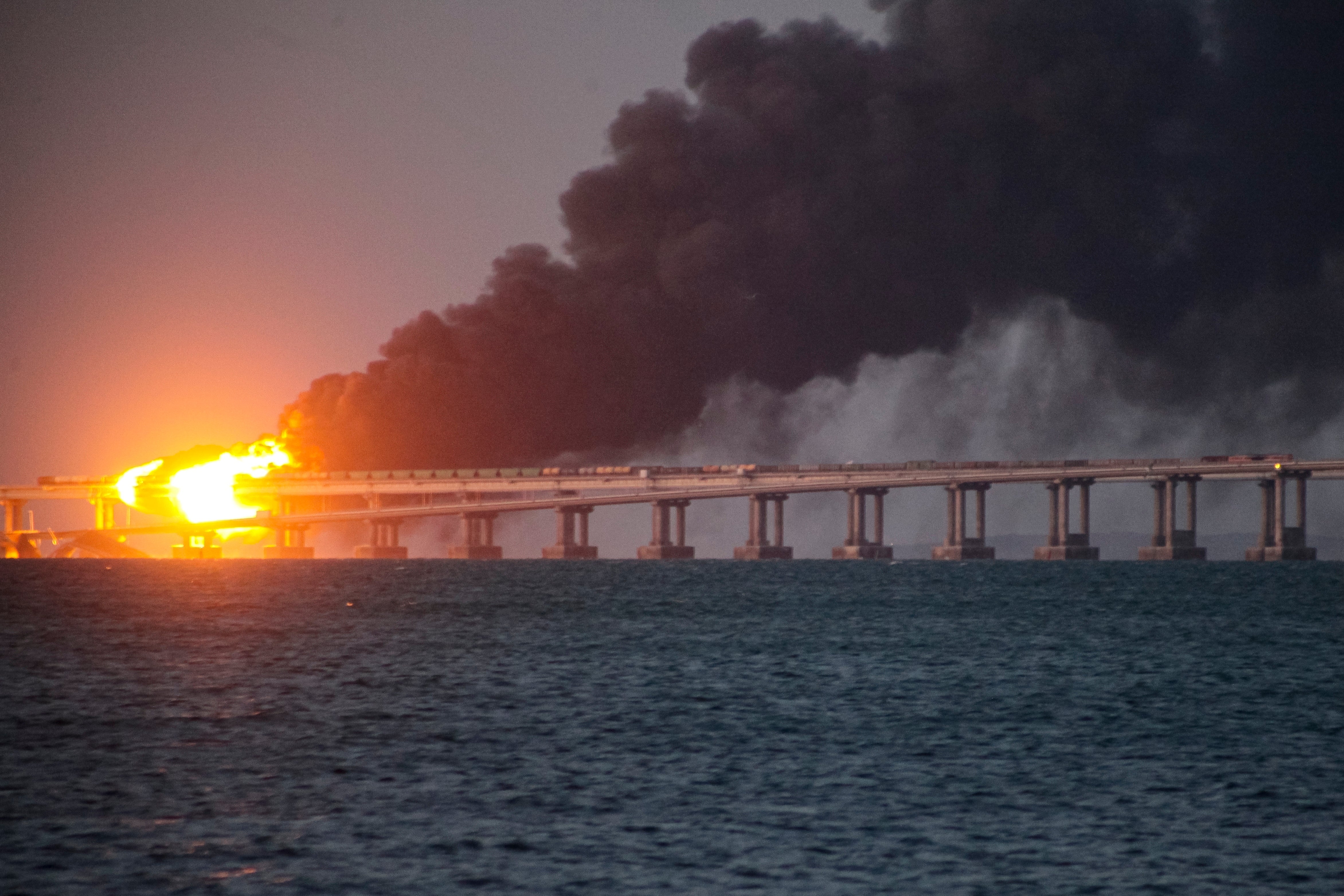 Flames and smoke rise after the explosion on the Crimea bridge