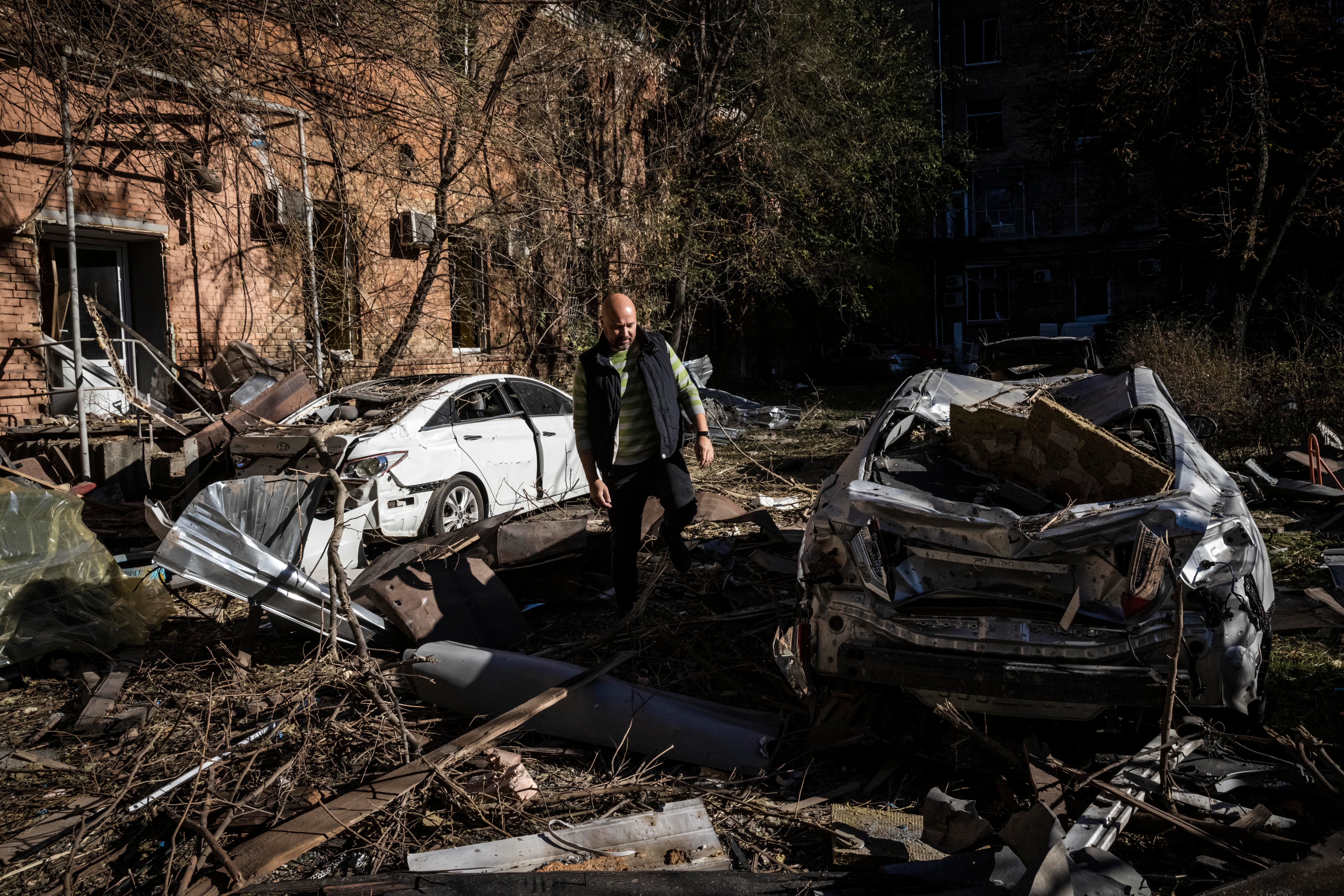 A Ukrainian man surveys the damage caused by a missile strike on a residential area near Kyiv's main train station