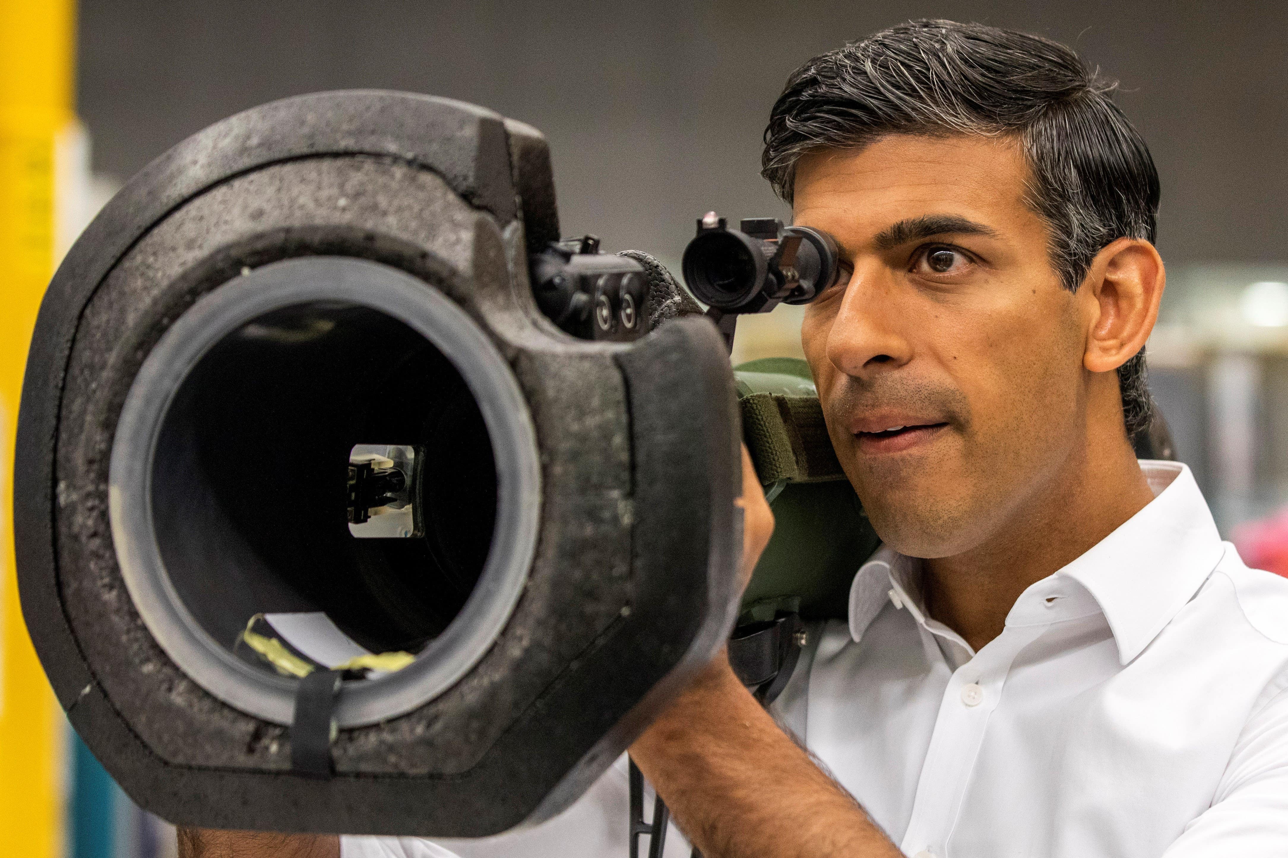 MP Rishi Sunak looks at an Nlaw anti-tank launcher, supplied to Ukraine, in August (PA)