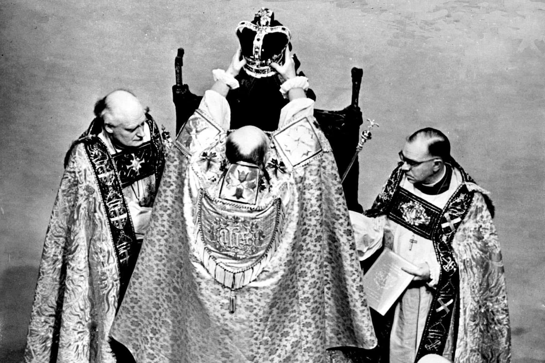 The Queen sits on the St. Edwards Chair, is crowned by the Archbishop of Canterbury (PA)