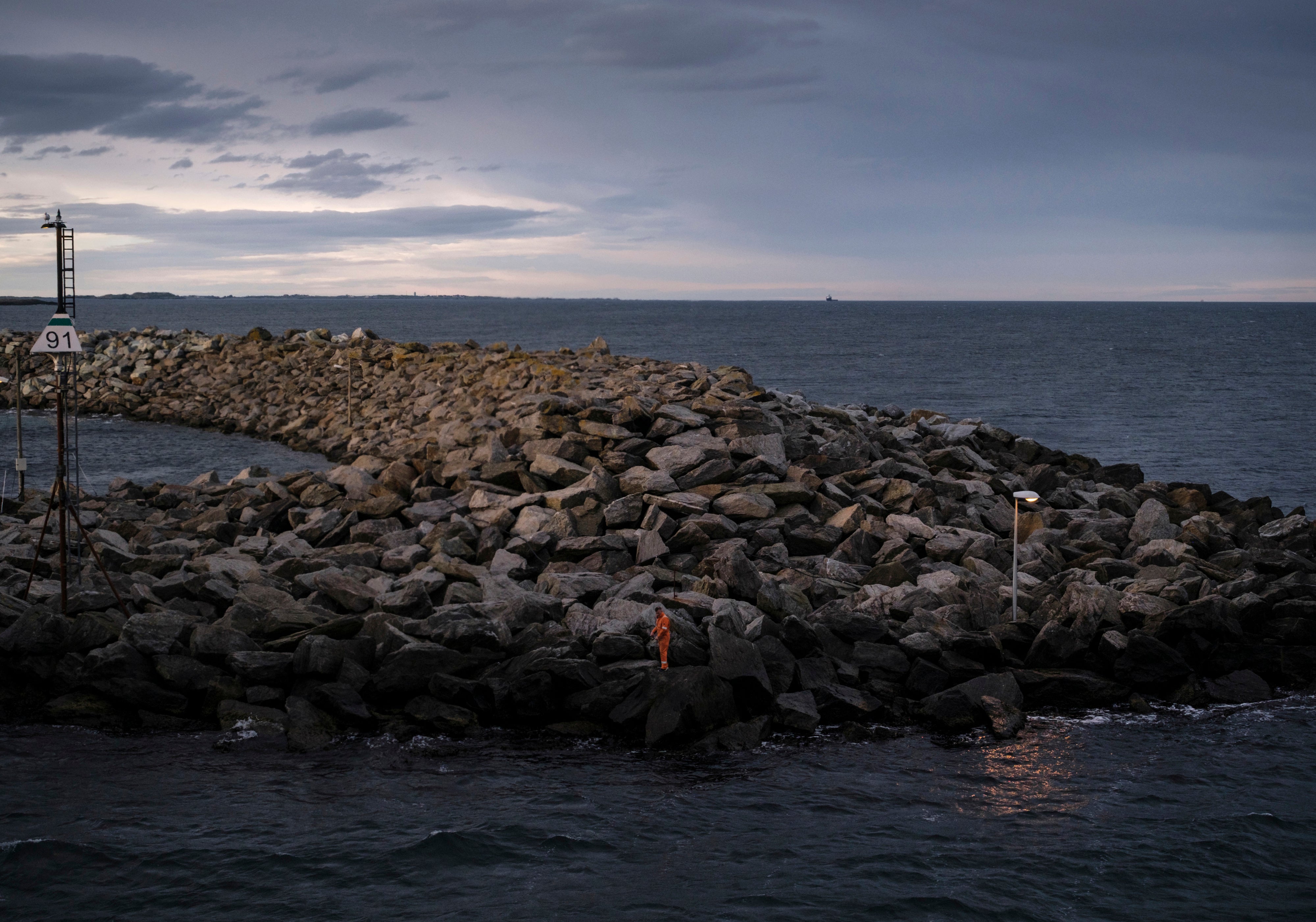 A fisher can be seen at a ferry dock near Stavanger. The region has benefited from the discovery of offshore oil