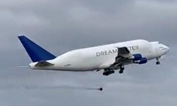 Smoke pours from the landing gear area before the tyre drops to the ground