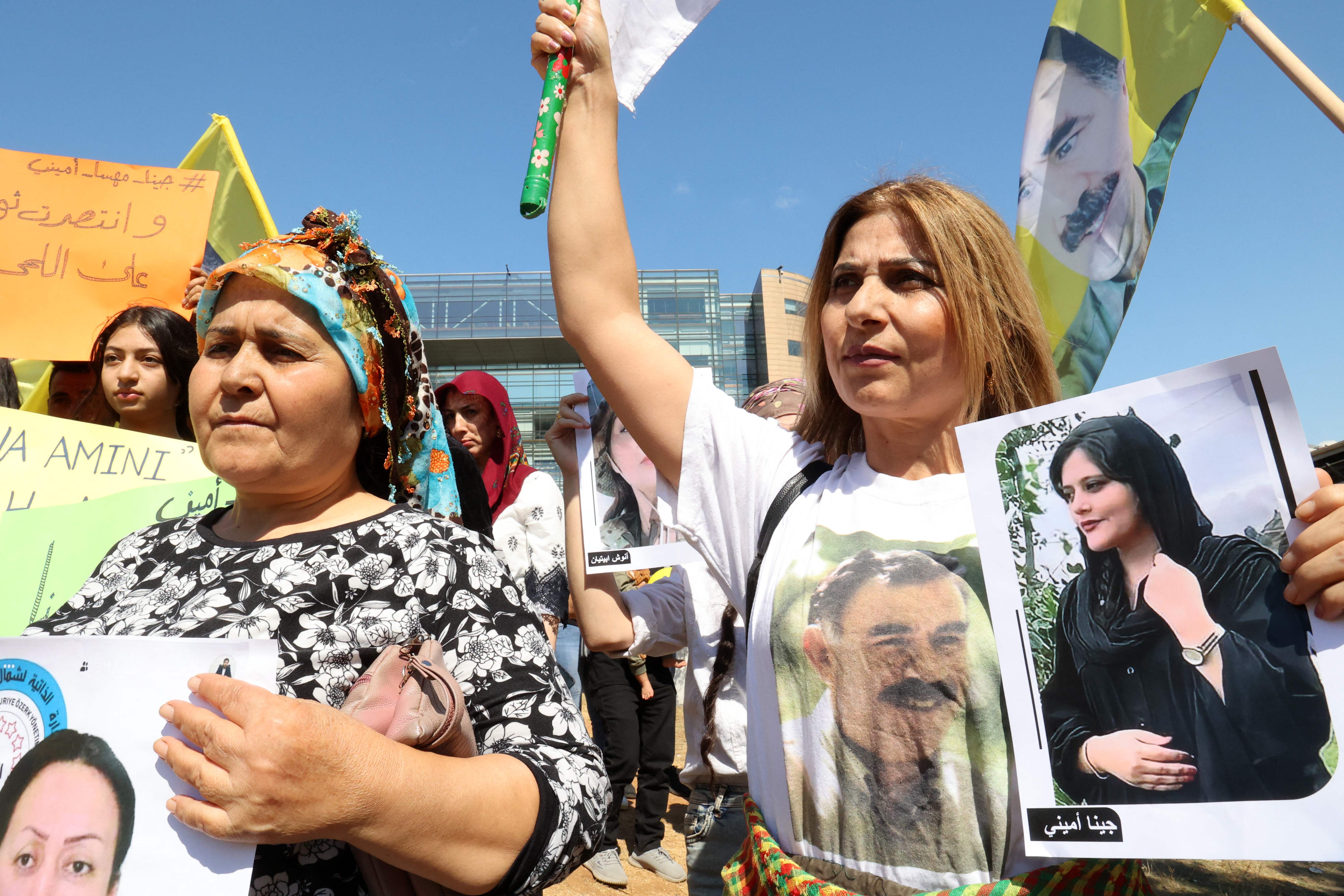 Kurdish women in Lebanon raise flags as they demonstrate in solidarity with recent protests in Iran