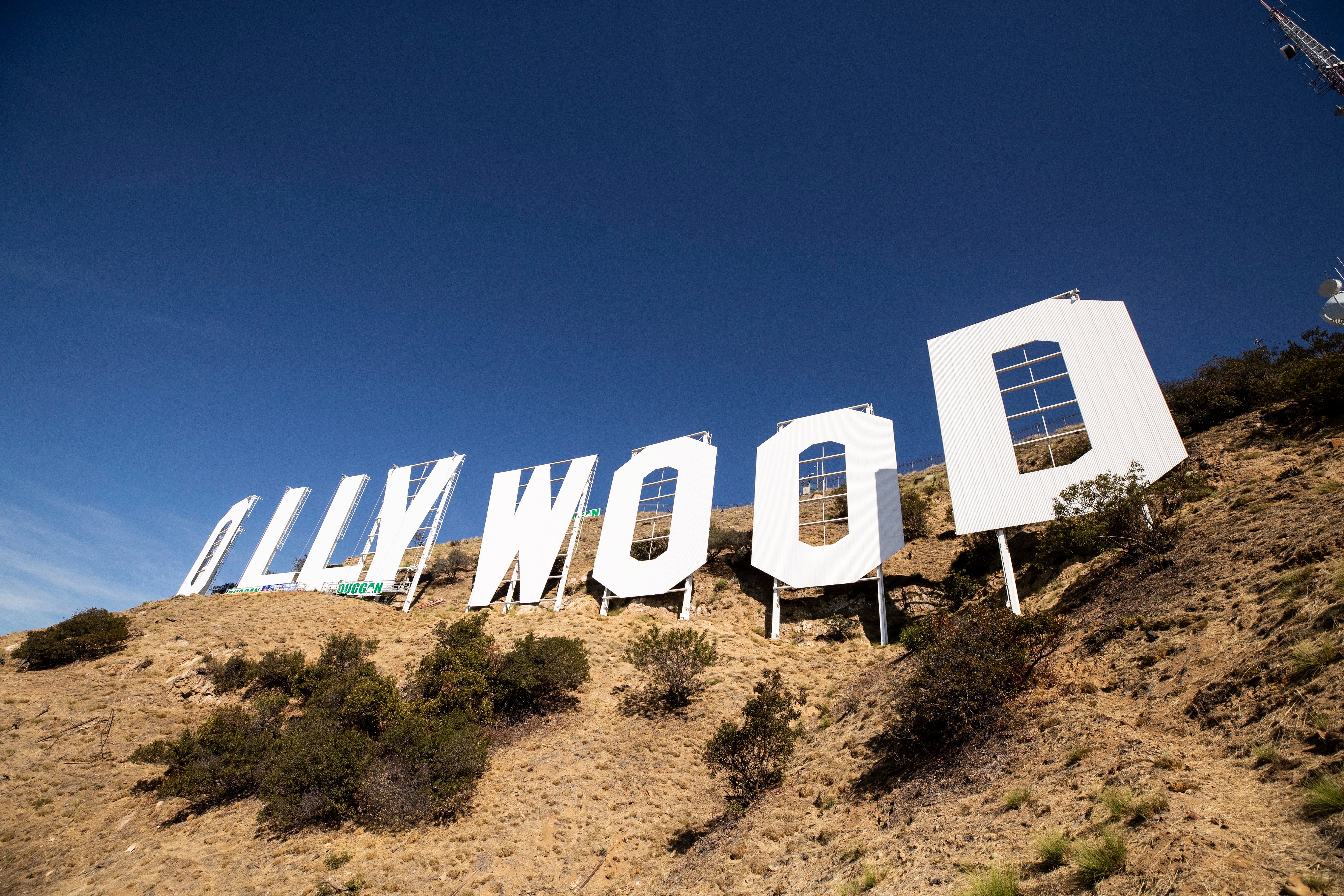 Workers repaint the Hollywood Sign during a restoration of the landmark, in the Hollywood Hills of Los Angeles, California,