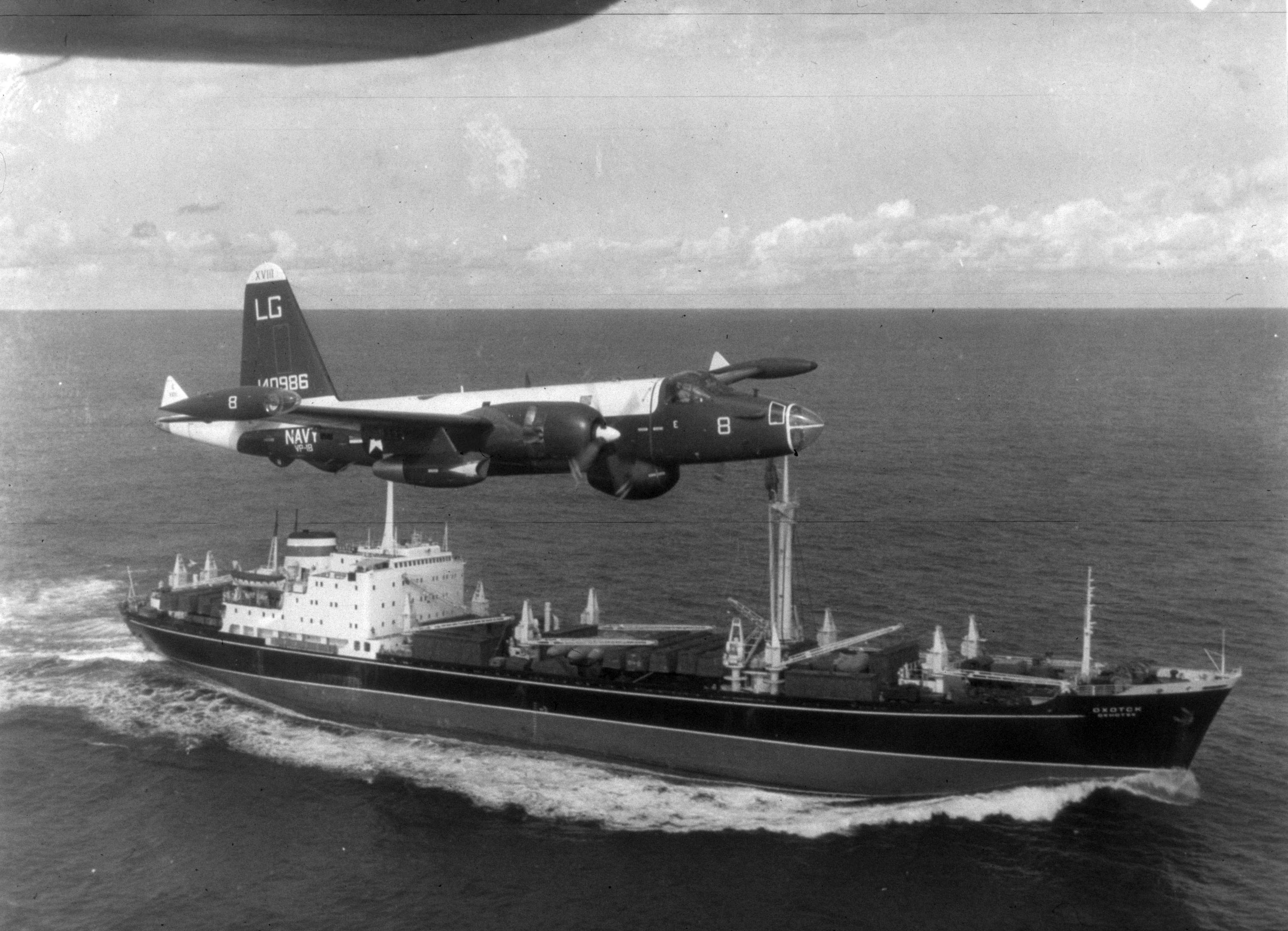 A P2V Neptune US patrol plane flies over a Soviet freighter during the Cuban missile crisis