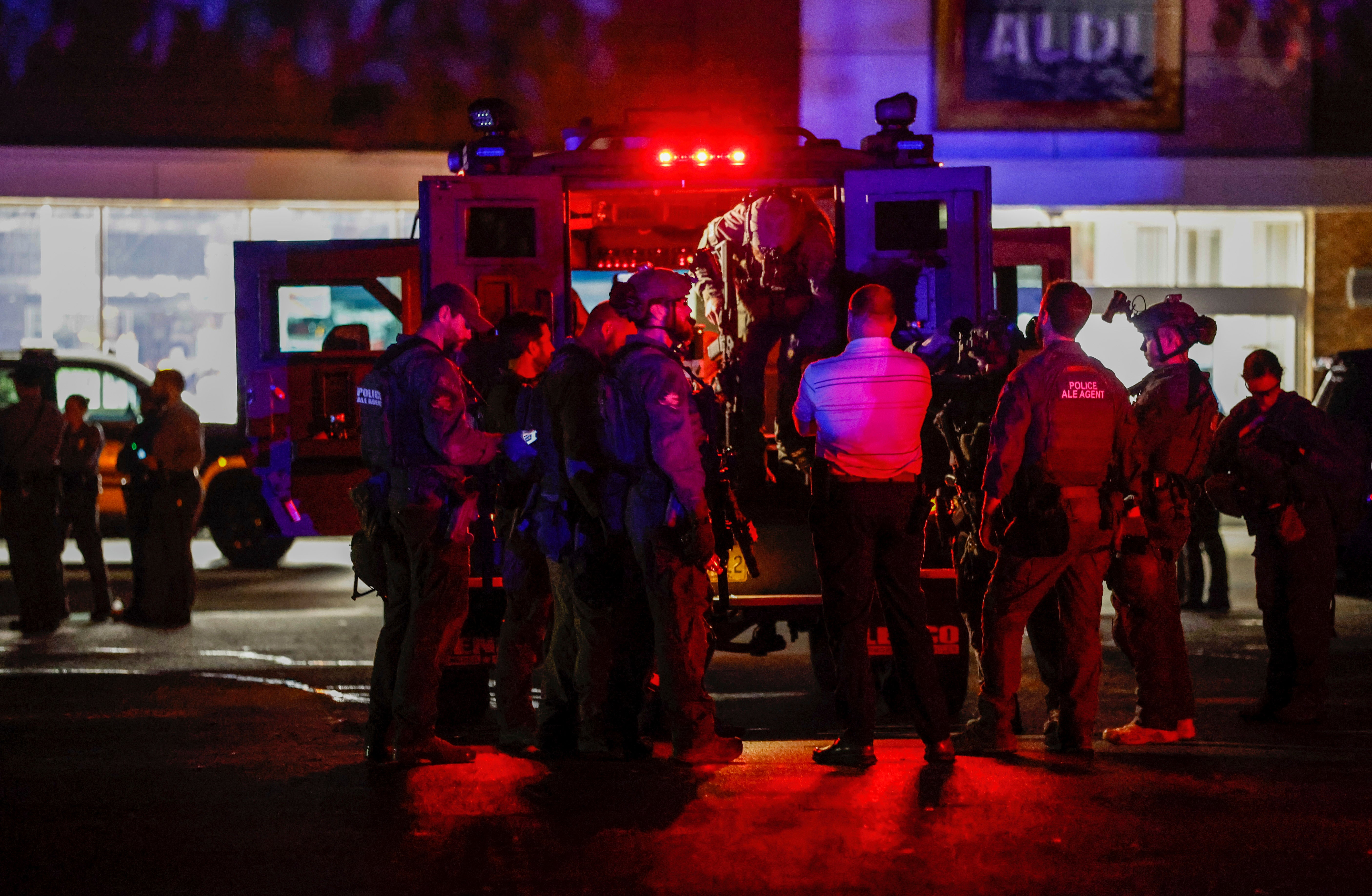 Law enforcement officers congregate outside an armored vehicle at the Aldi on New Bern Avenue in Raleigh