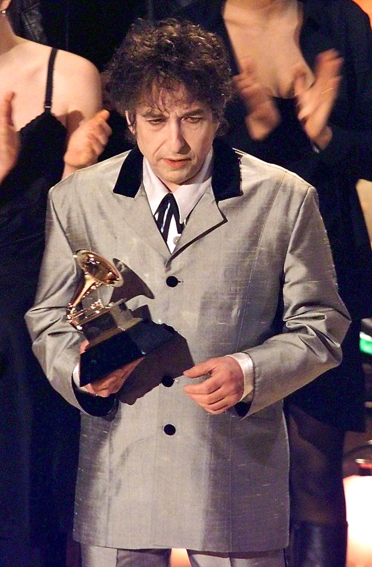 Bob Dylan holds his Grammy Award after winning Album of the Year in New York in 1997