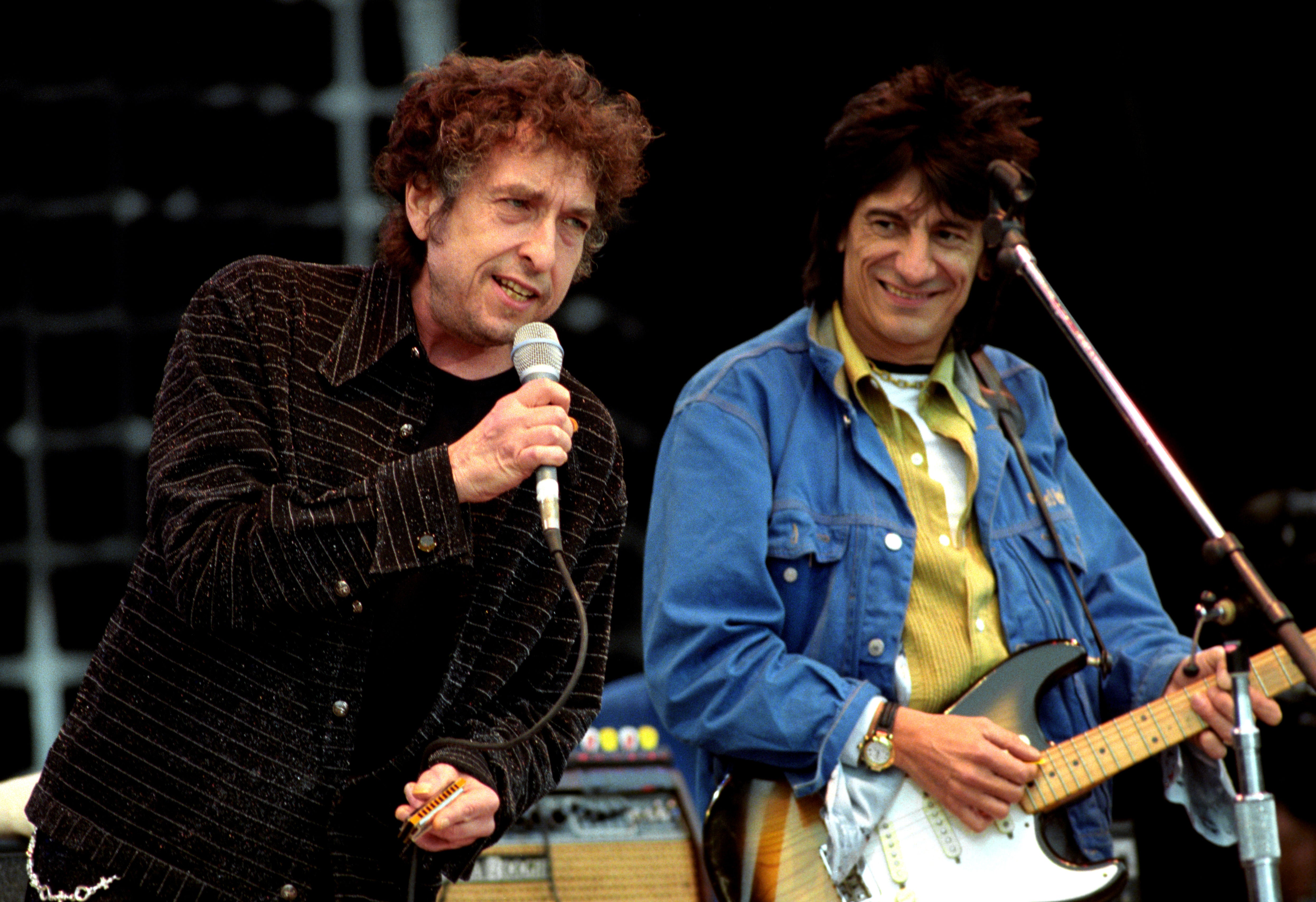 Bob Dylan is joined on stage by Rolling Stones guitarist Ronnie Wood during a 1996 gig