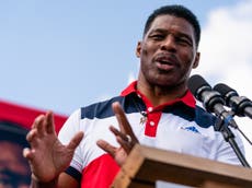 Georgia debate – live: Moderator scolds Herschel Walker for ‘prop’ police badge