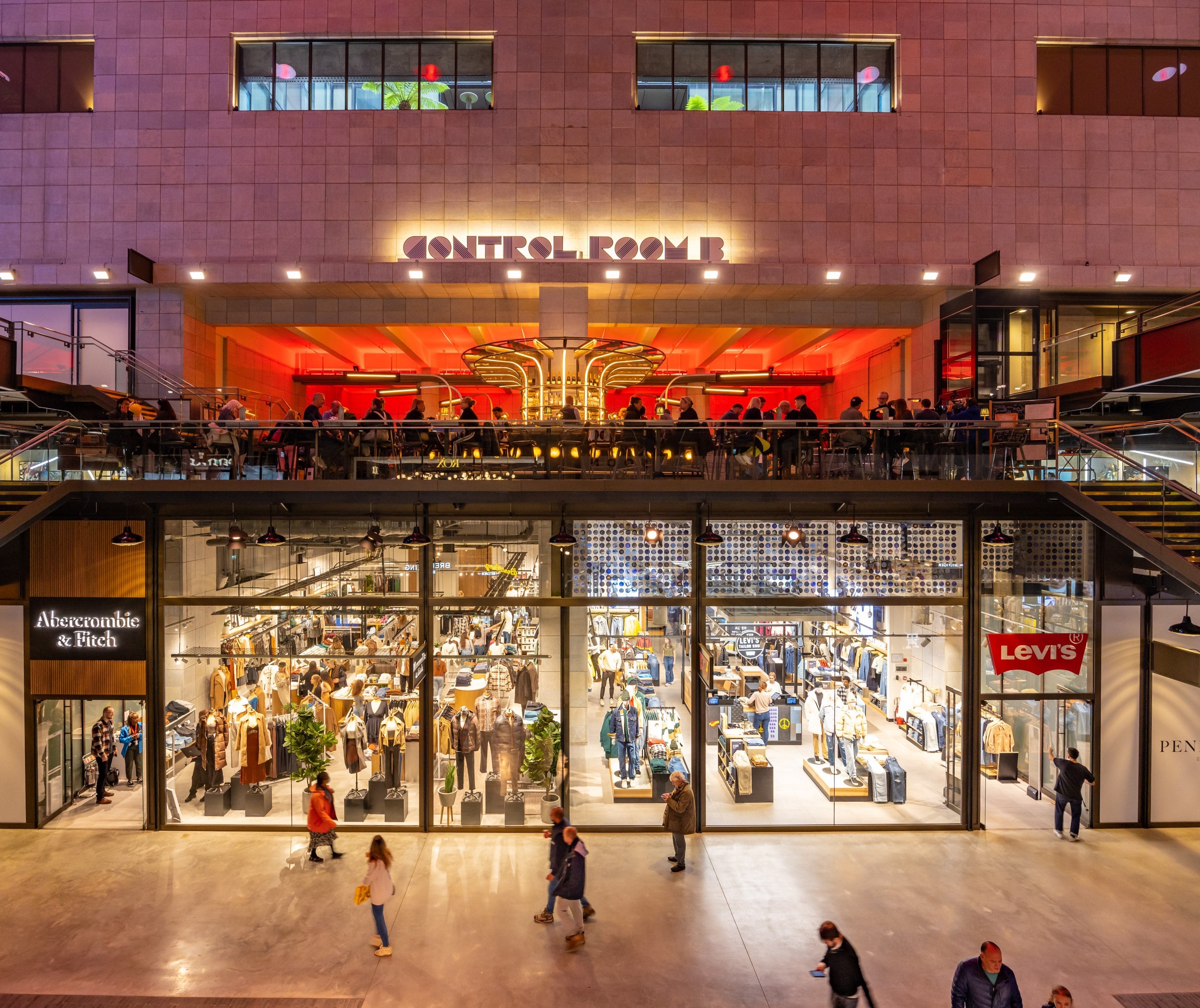 Fashion boutiques are topped by a bar spotlighting the building’s Control Room B