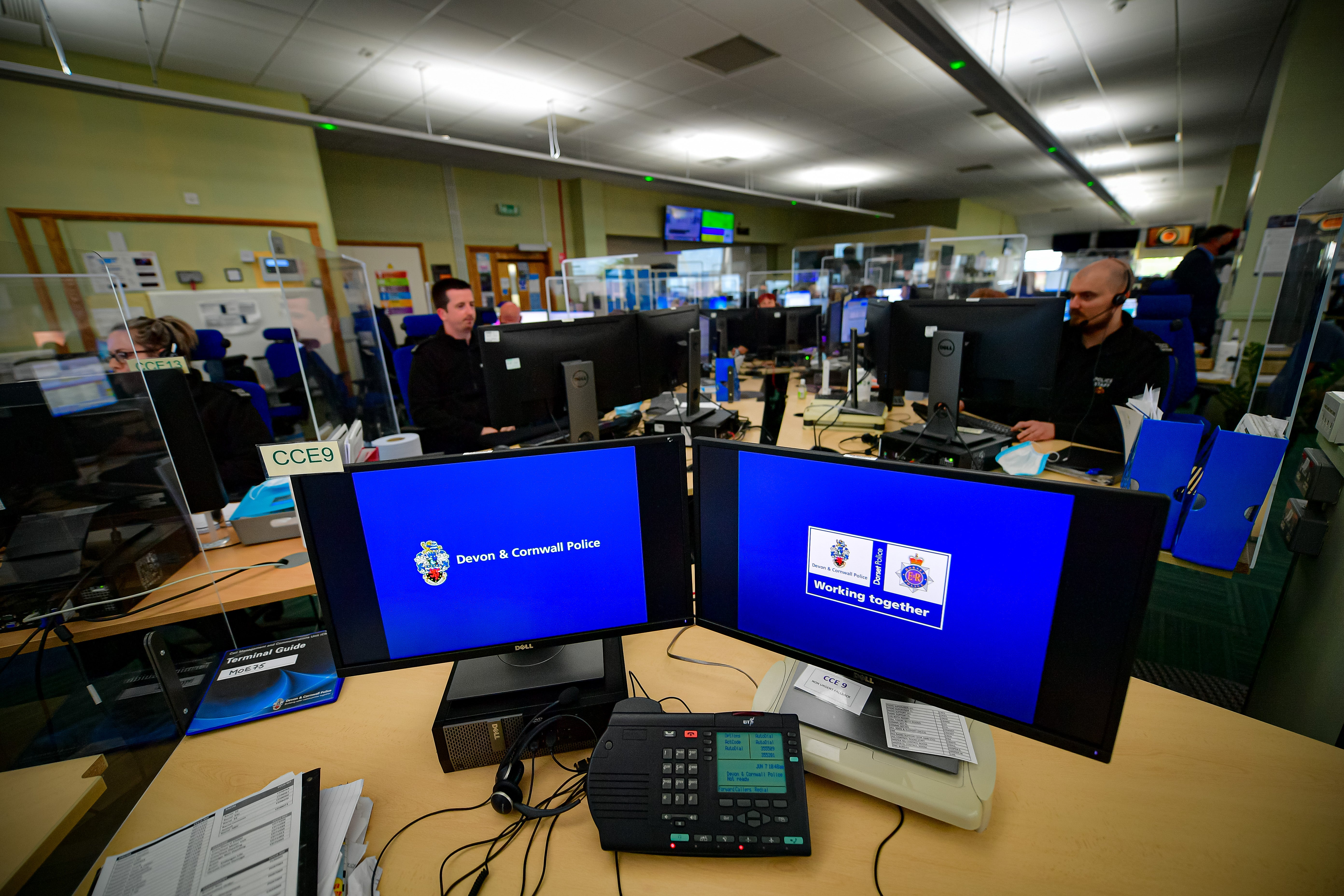 Police staff operate 999 emergency phone lines in the control room at Exeter Police HQ, Devon