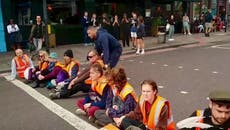 Member of public drags Just Stop Oil protester from road as group halt traffic in Shoreditch