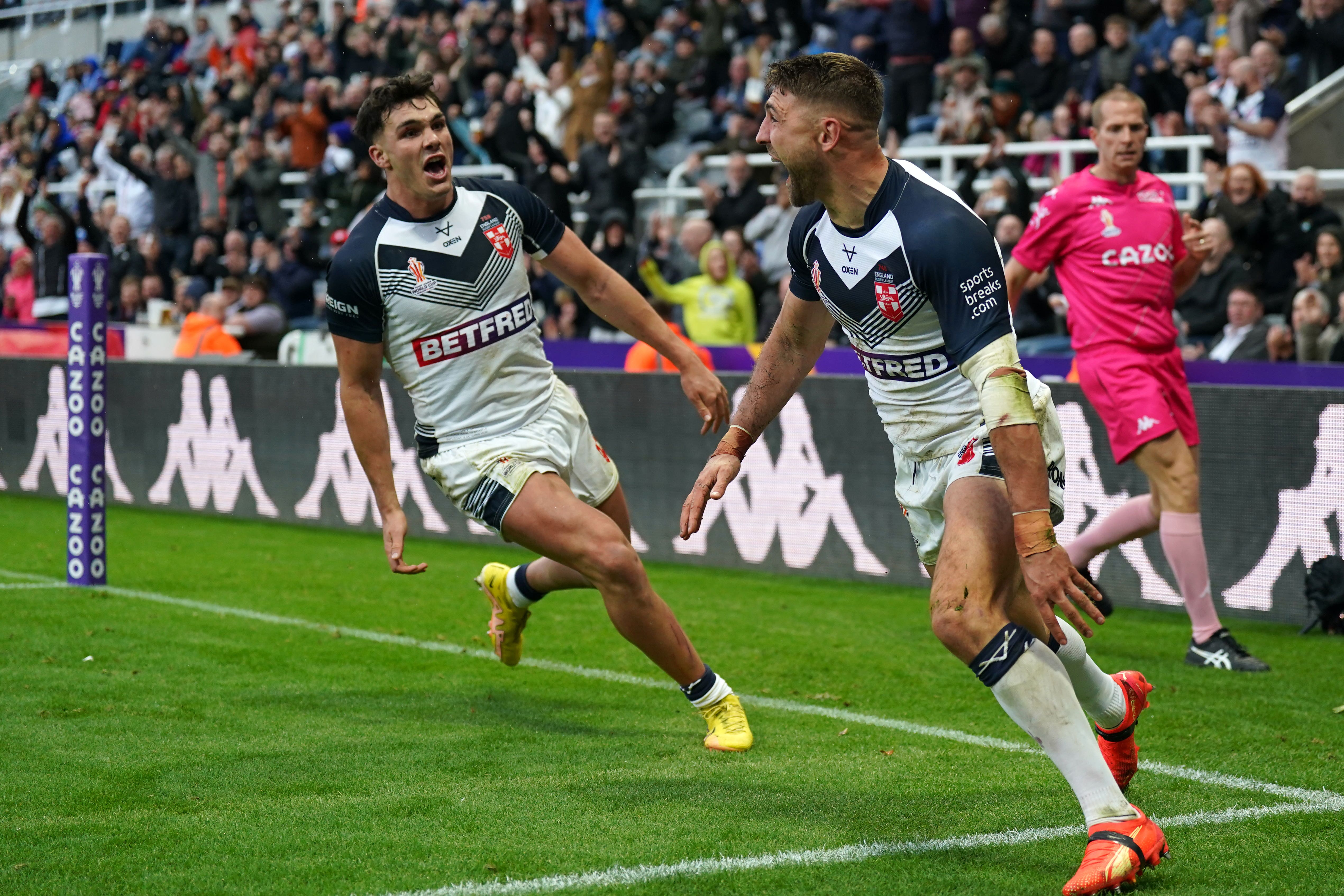 England’s Tommy Makinson, right, celebrates his try against Samoa (Owen Humphreys/PA)