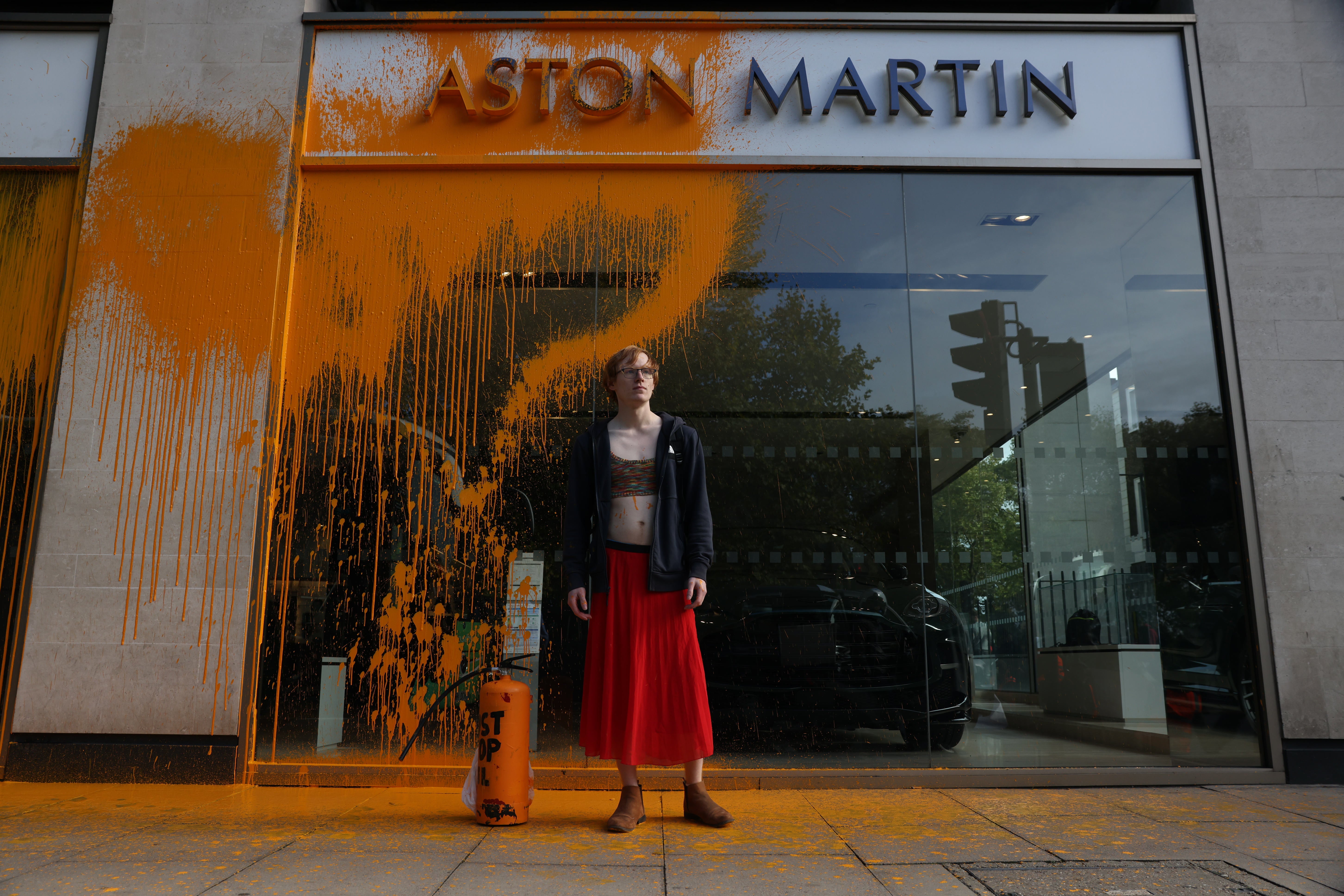 Protester glued themselves to the Tarmac outside the Aston Martin store on Sunday