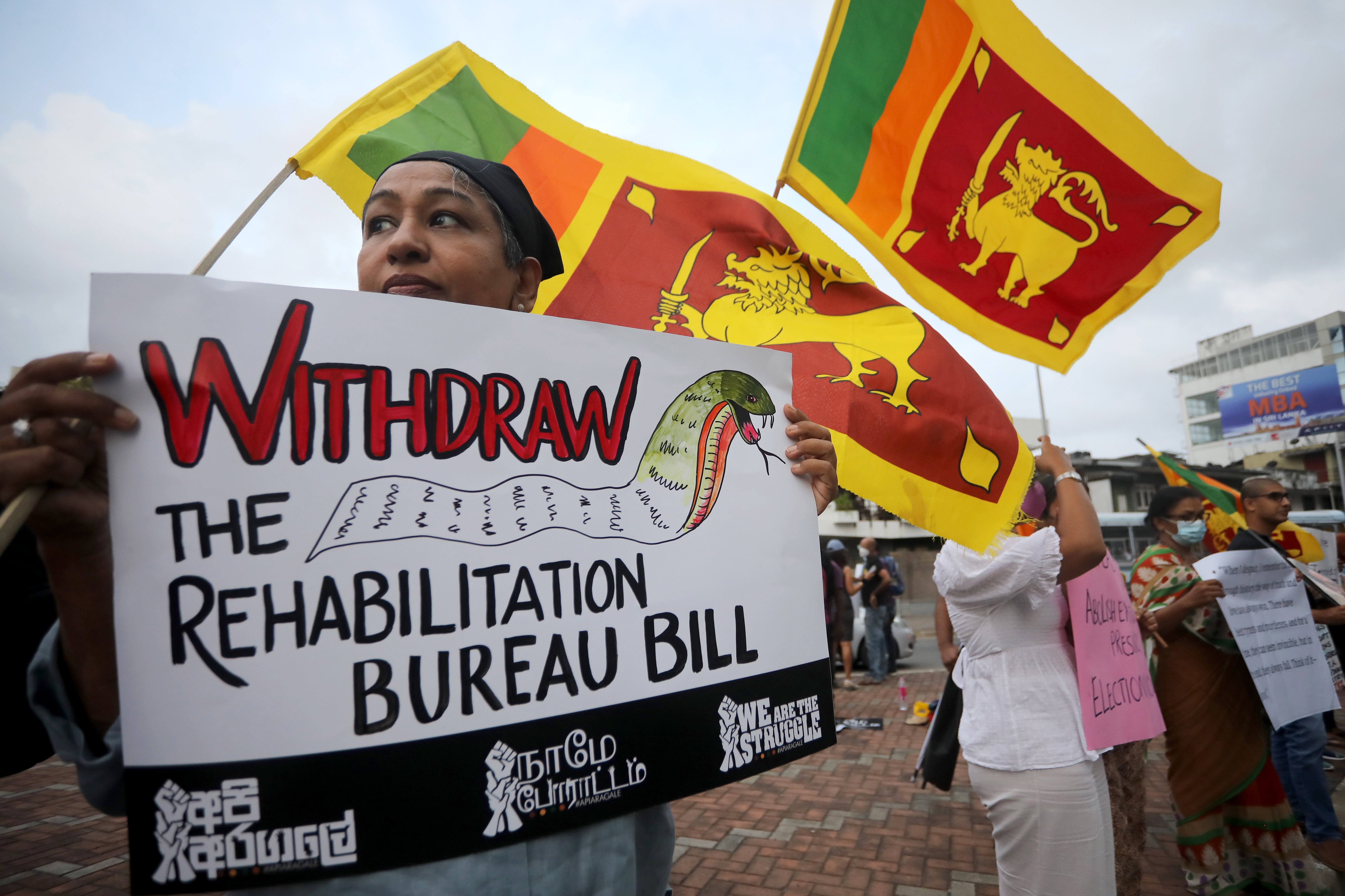 Anti-government protesters hold placards and national flags during a protest against the current economic and political crisis, in Colombo, Sri Lanka, 07 October