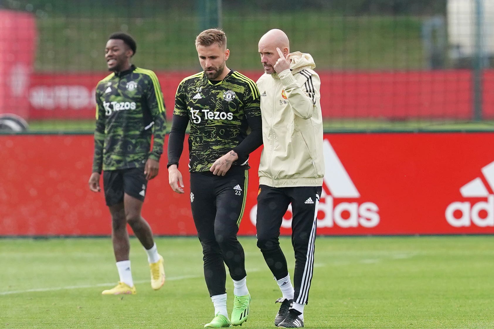 Manchester United’s Luke Shaw talks with manager Erik ten Hag during a training session (PA)