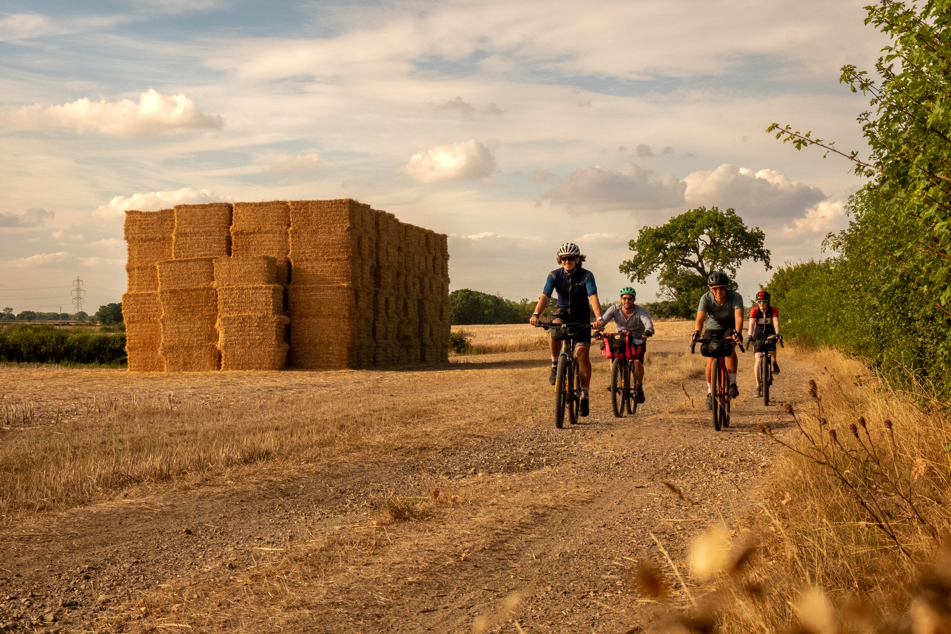 ‘The double line dirt track leads us across the empty field, its cut hay baled high in square stacks'