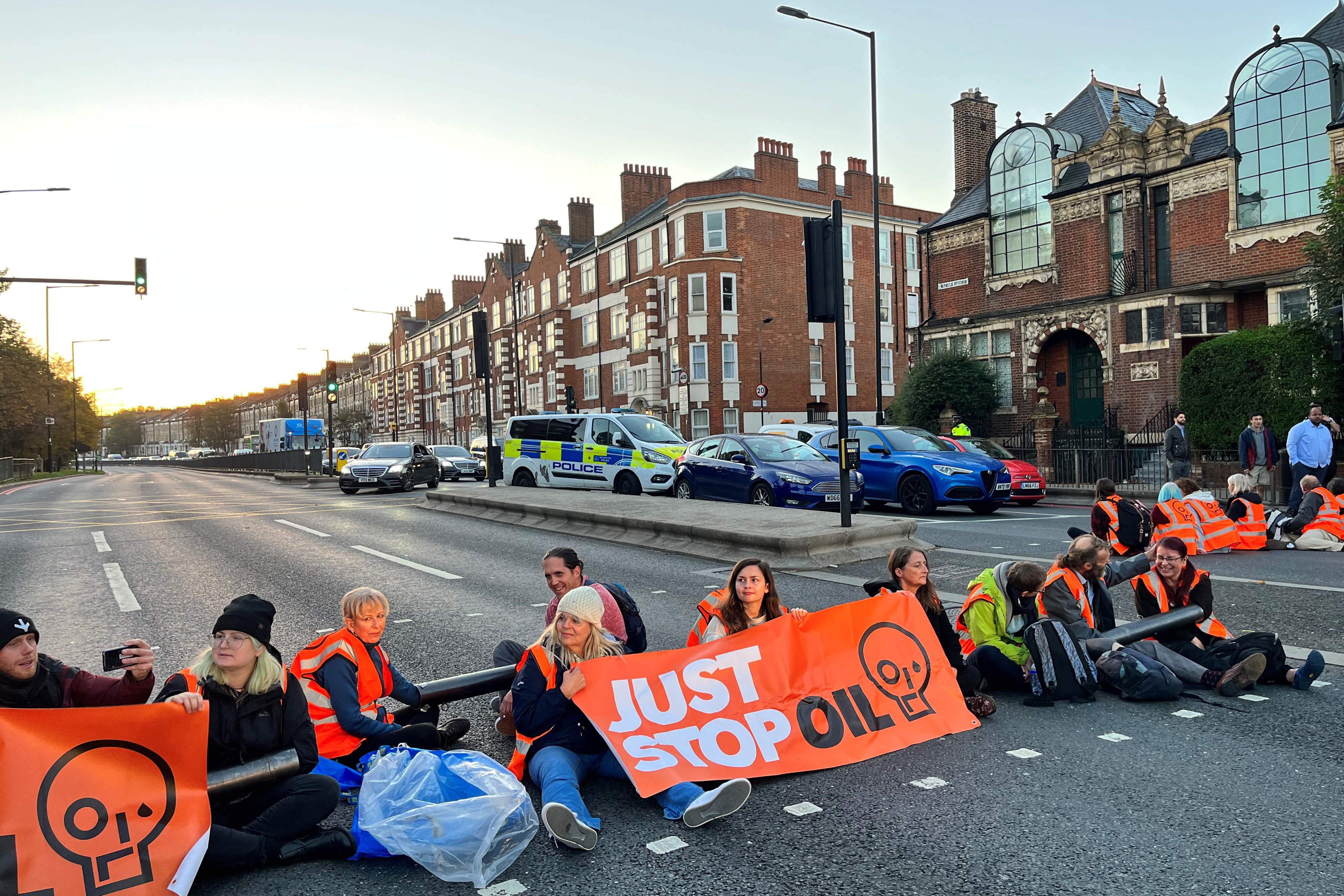 Activists have blocked a road outside Barons Court in west London