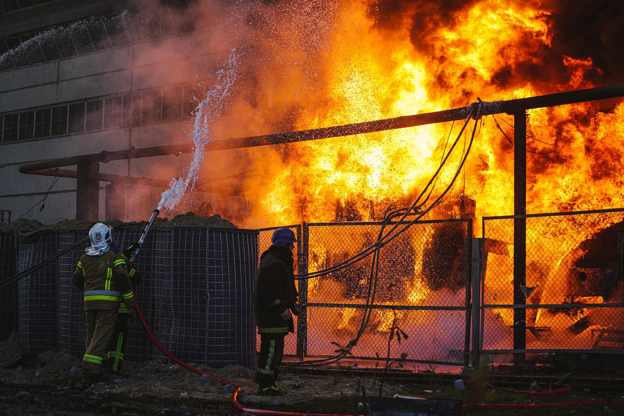 Firefighters work to put out a fire in a thermal power plant, damaged by a Russian missile strike in Kyiv