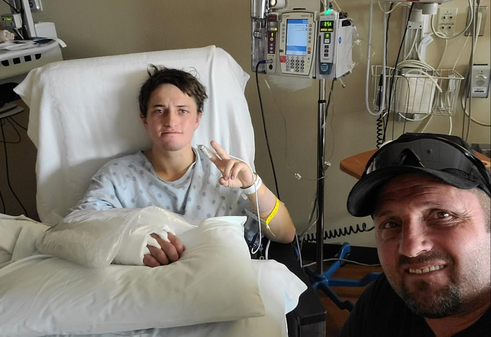 Brady Lowry, pictured with his father Dallas, is recovering in hospital after being attacked by a grizzly bear