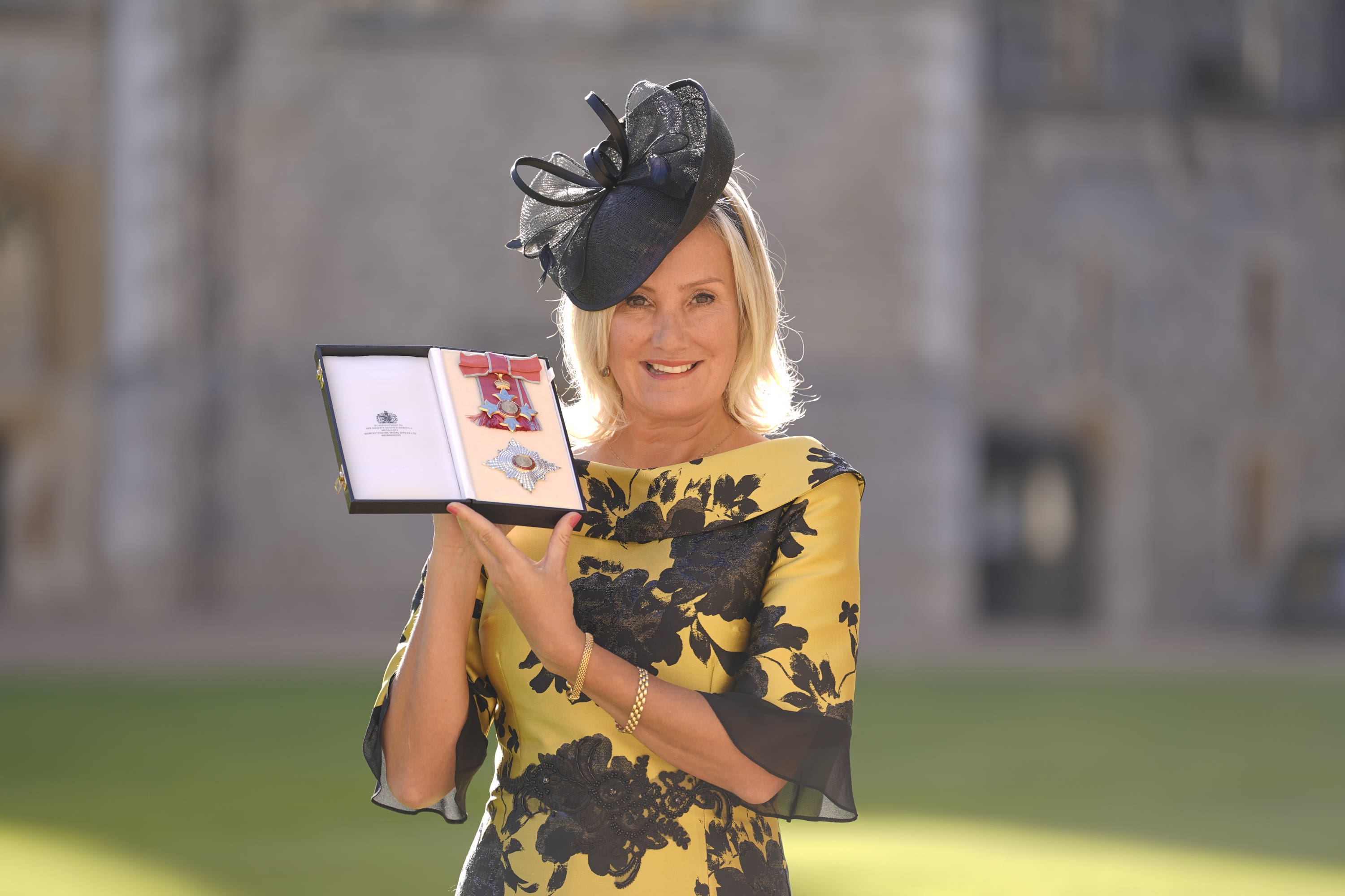 Dame Caroline Dinenage, MP for Gosport, holds her Dame Commander of the British Empire medal (Andrew Matthews/PA)