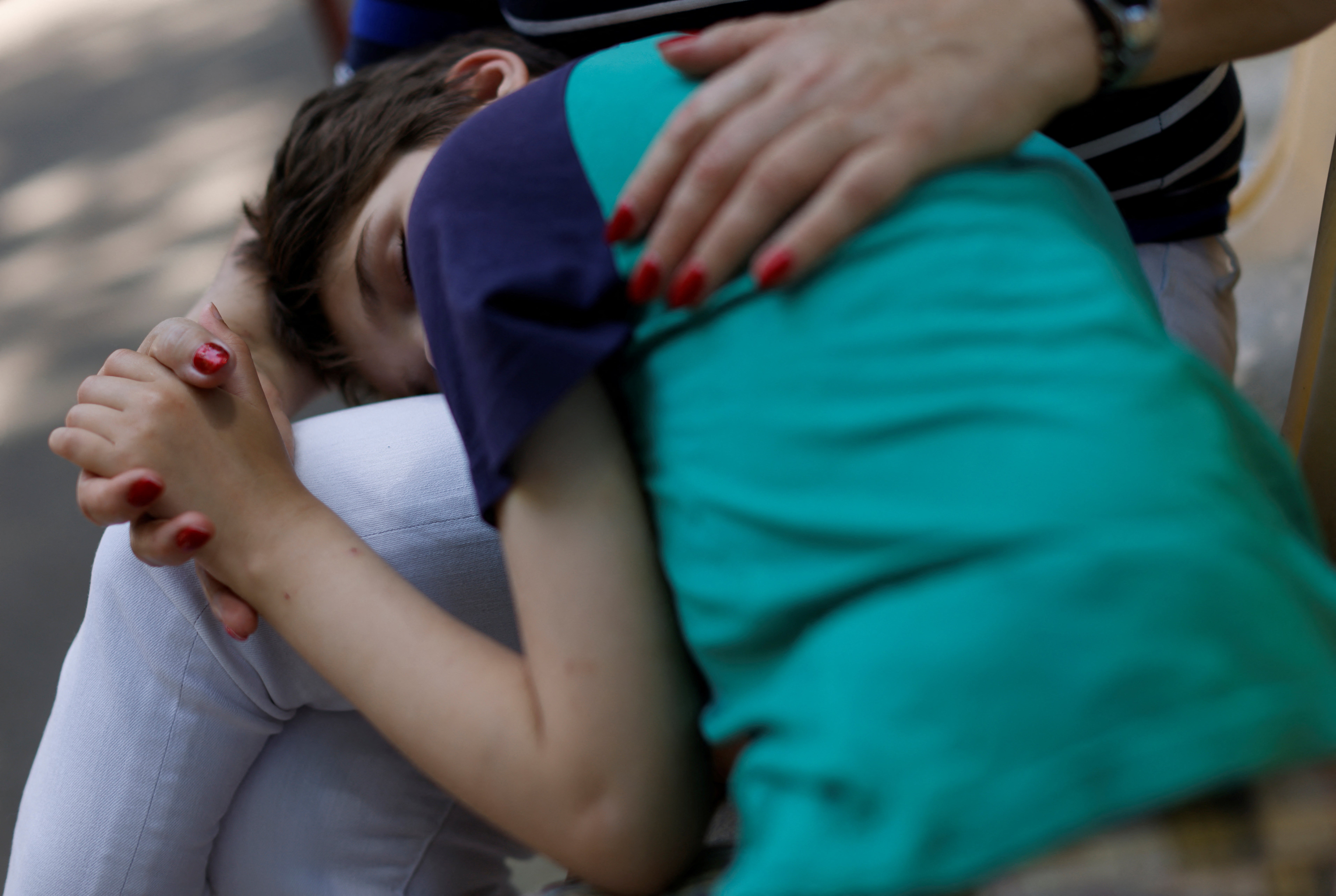 Tanya is comforted by a member of staff at the Odesa orphanage