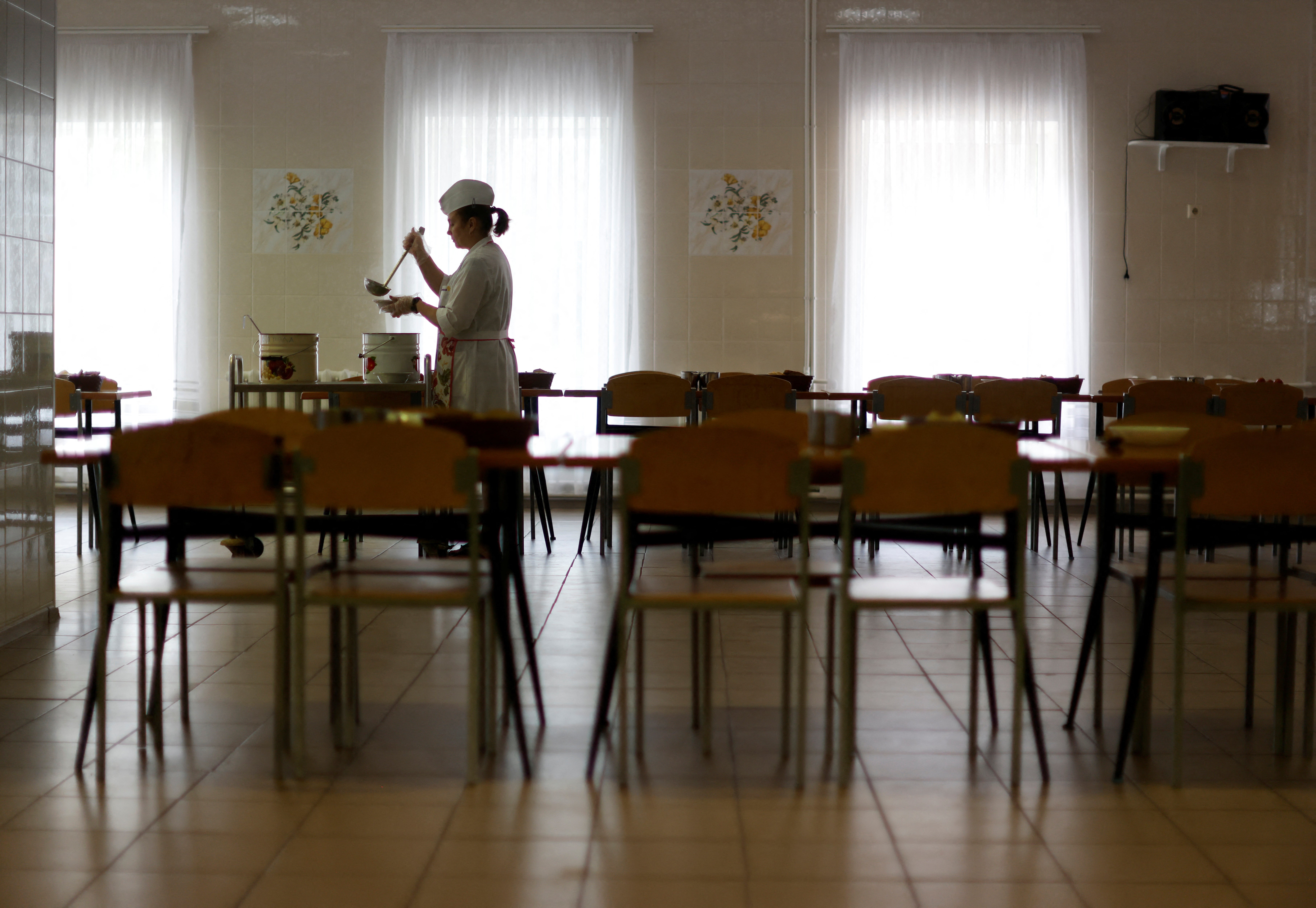 Staff member Oksana Kogat prepares soup in the dining hall