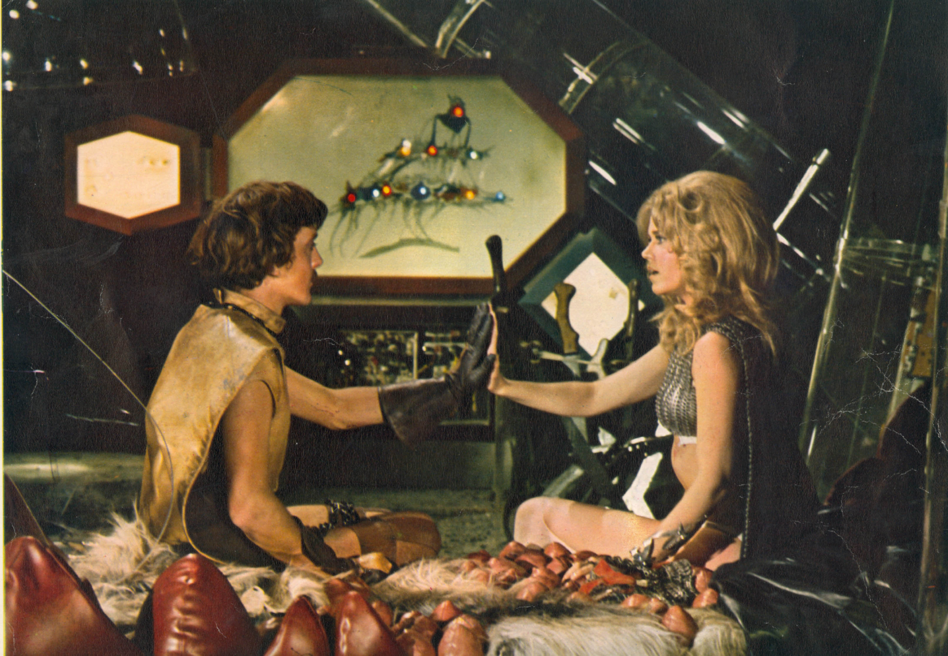 David Hemmings as Dildano and Fonda as Barbarella in a world where lovemaking is conducted by taking pills and pushing palms together until full rapport is achieved