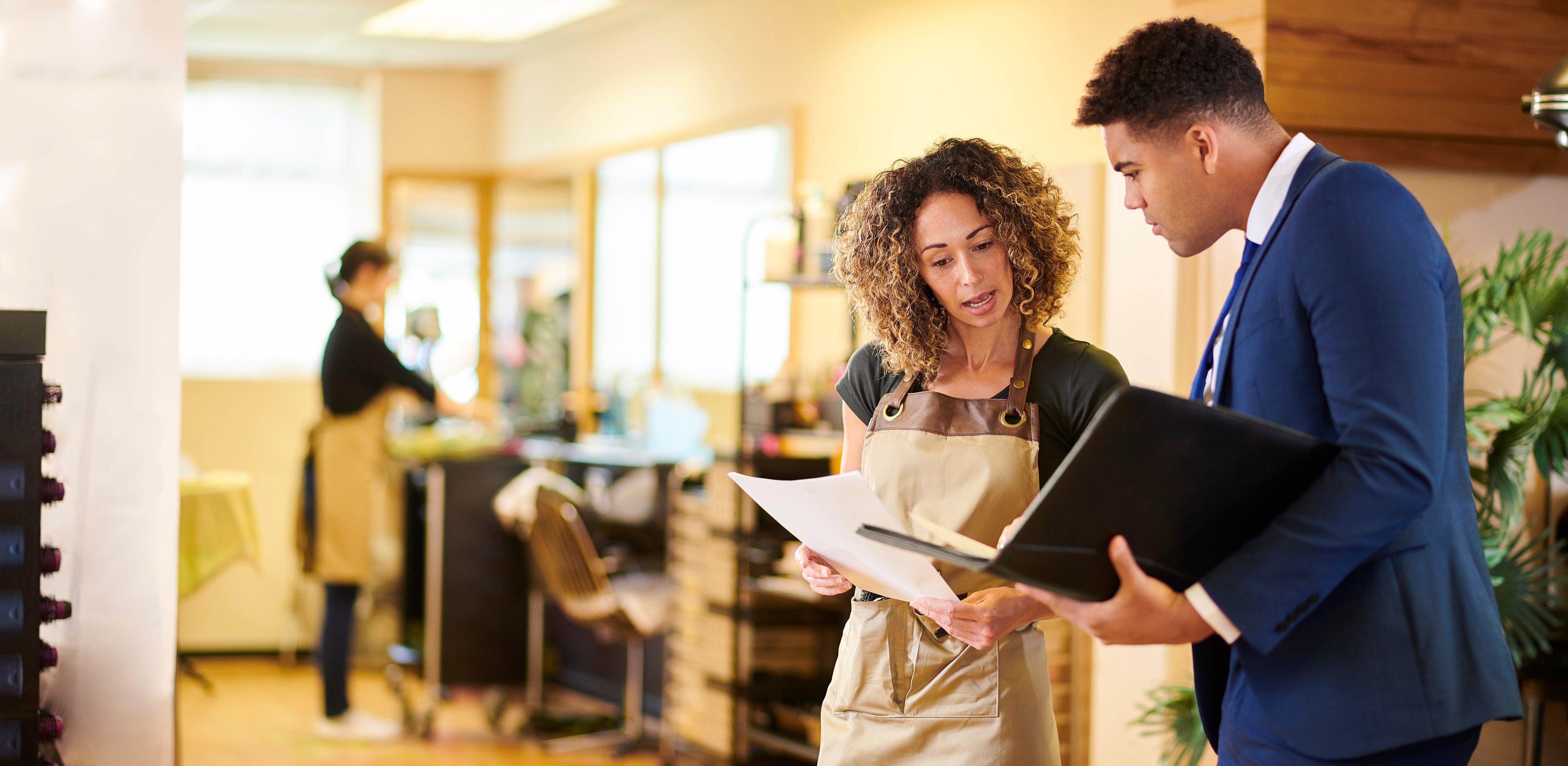 Hair salon owner chatting to salesman