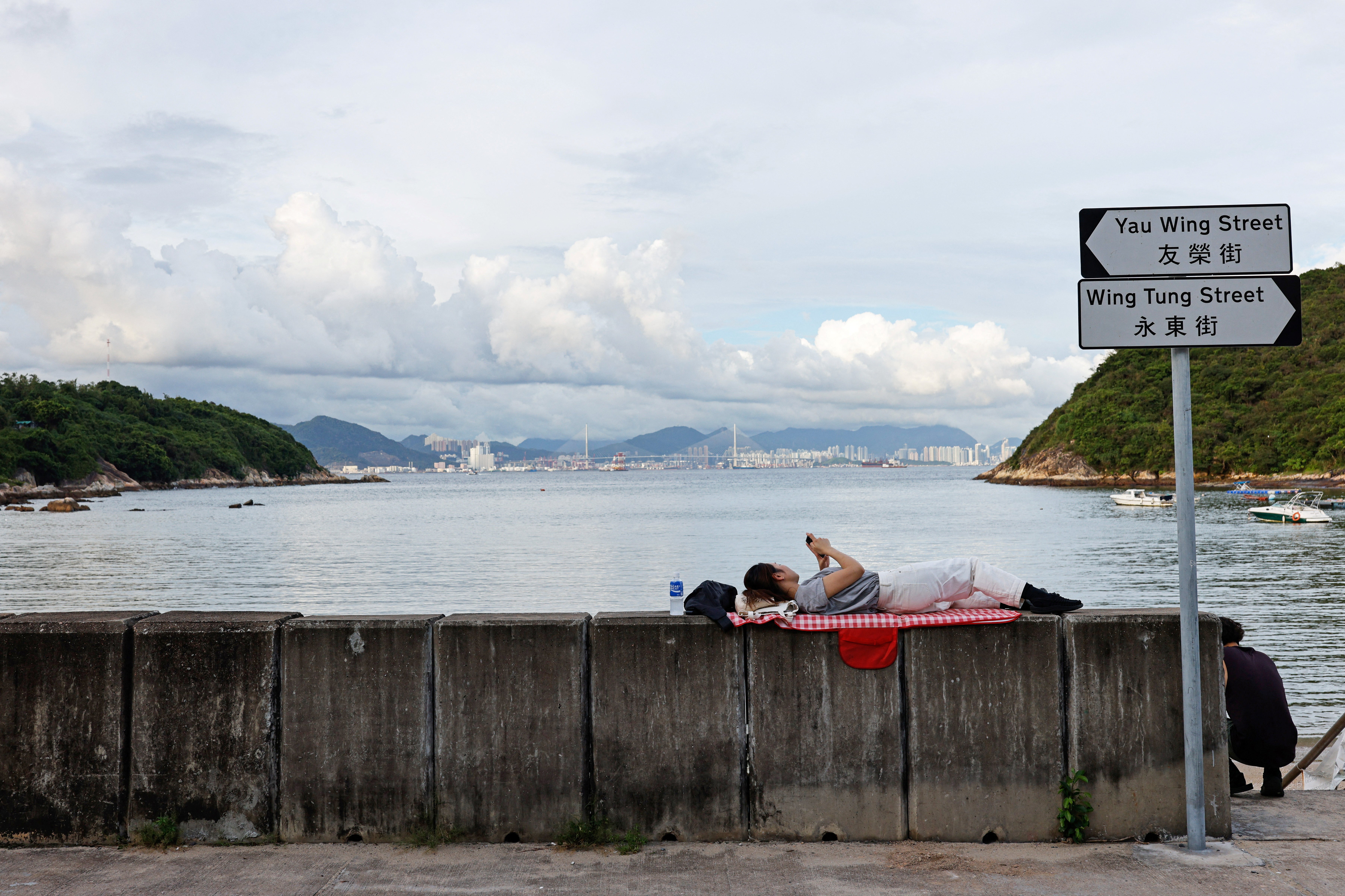 A woman relaxes near the seashore