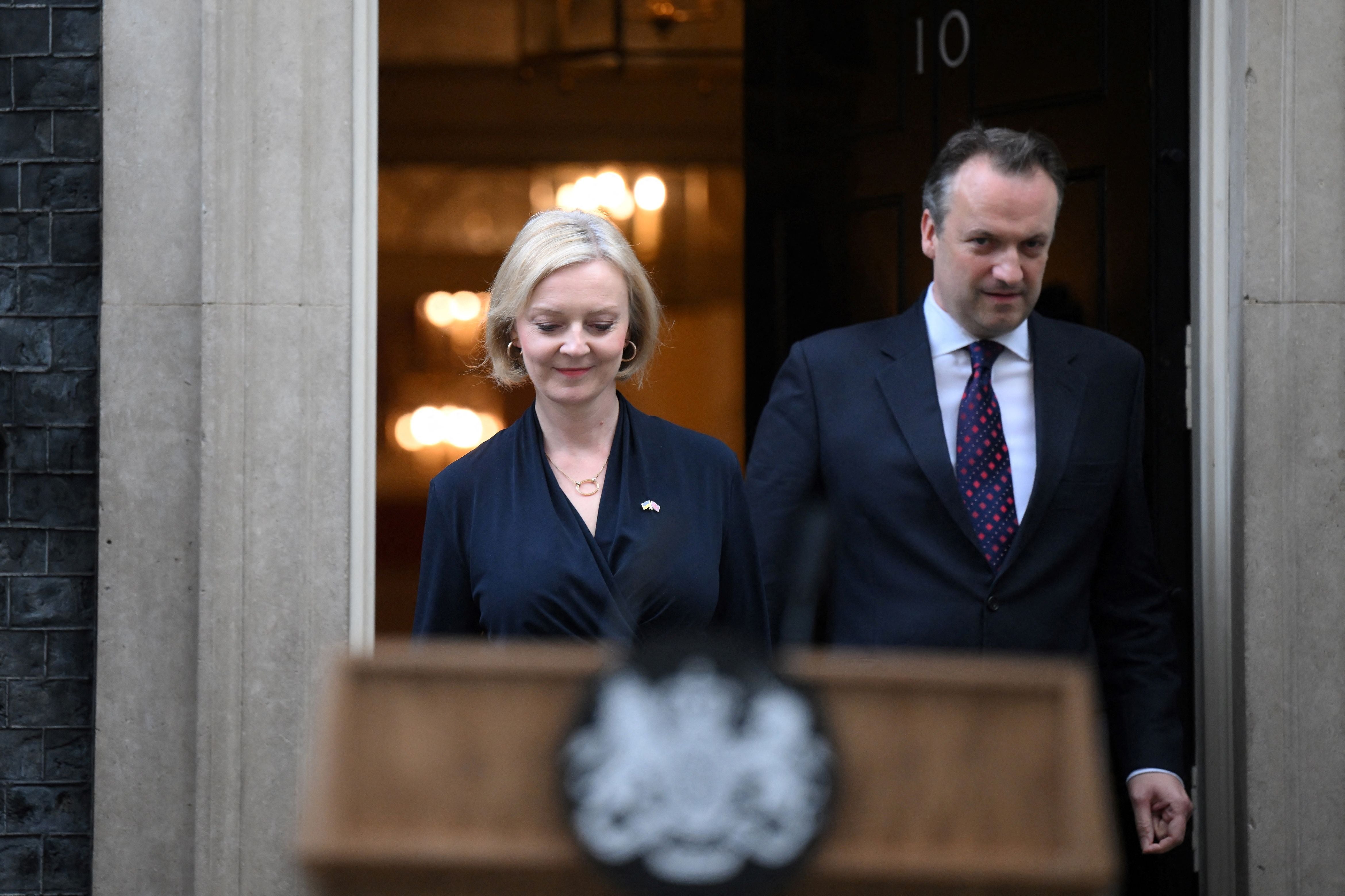 Liz Truss announces her resignation flanked by her husband Hugh O’Leary