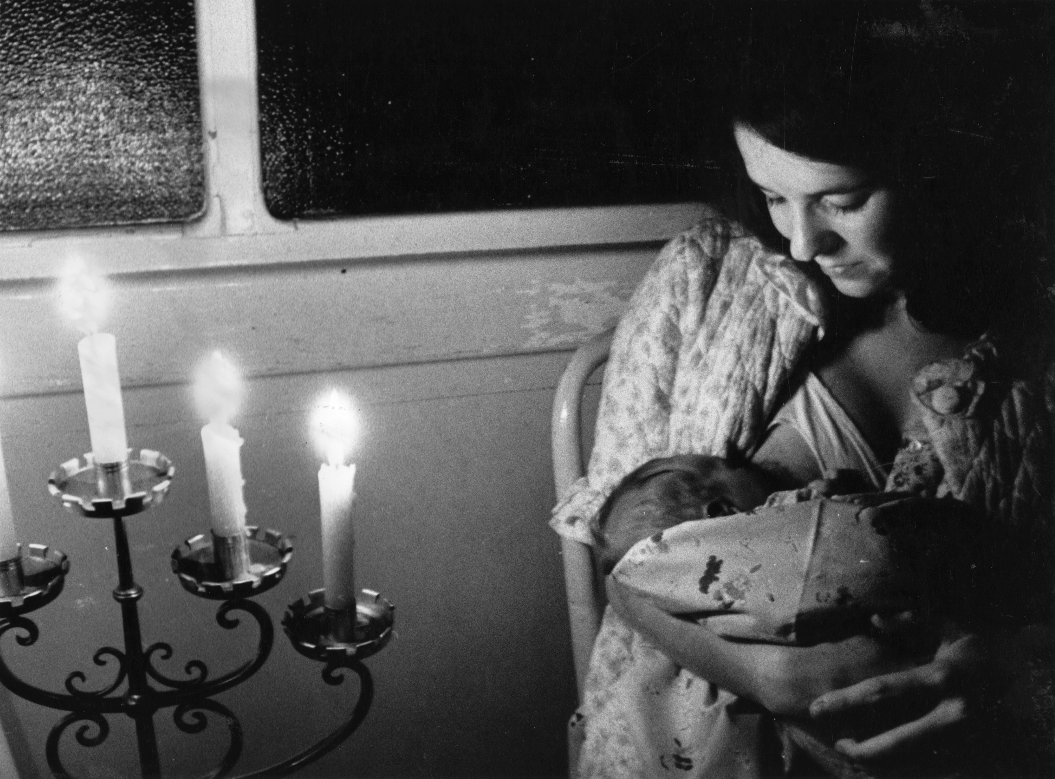 A woman breast feeding her baby during a blackout in the maternity unit at St Andrews Hospital, Dollis Hill