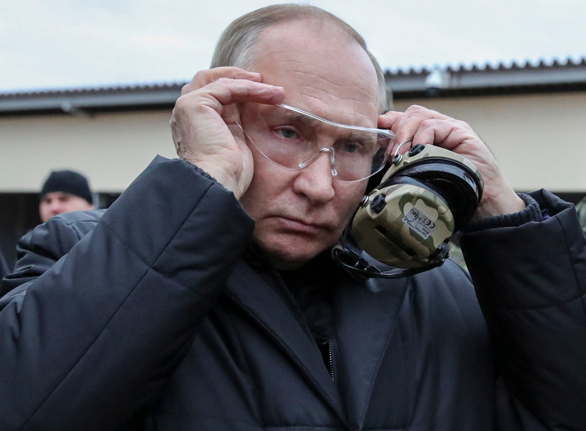 Russian President Vladimir Putin puts on tactical glasses as he inspects the progress of mobilized servicemen’s training at a training range in the Ryazan region, Russia