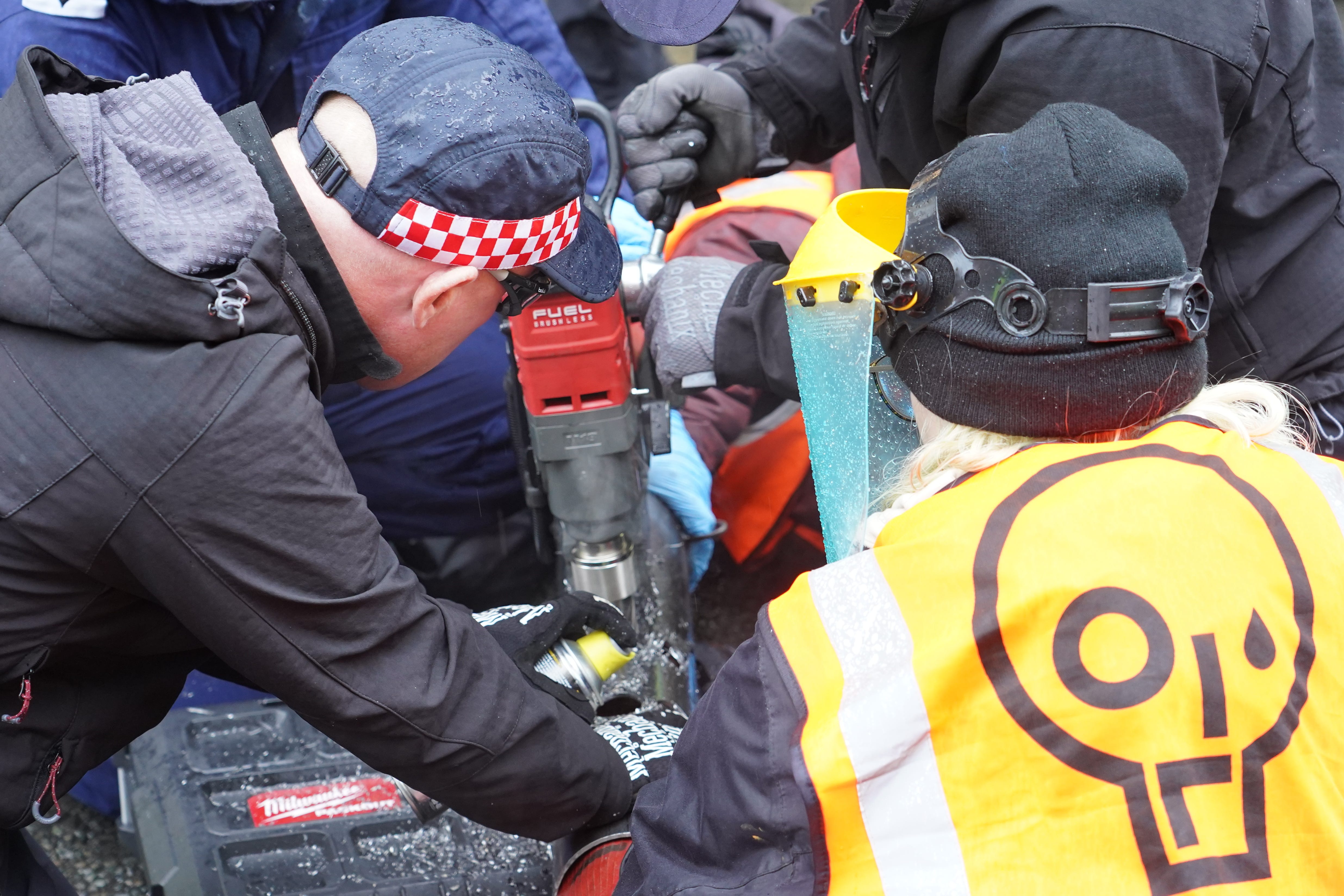 Police officers deal with activists from Just Stop Oil during their protest outside Harrods department store in Knightsbridge, London. Picture date: Thursday October 20, 2022 (Ian West/PA)