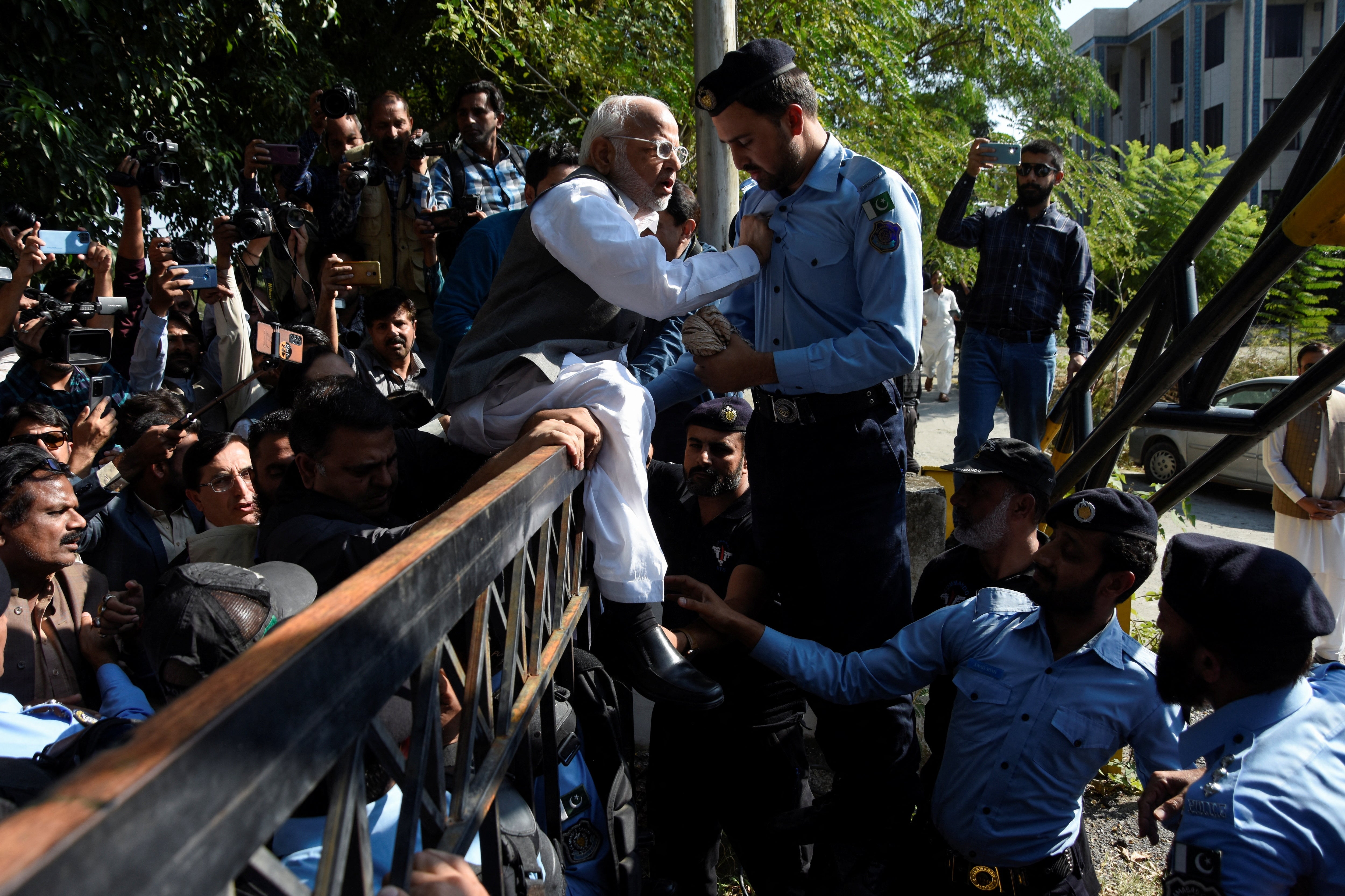 Police officers engage with supporters of the Pakistan Tehreek-e-Insaf political party after Pakistan’s Election Commission disqualified former prime minister Imran Khan