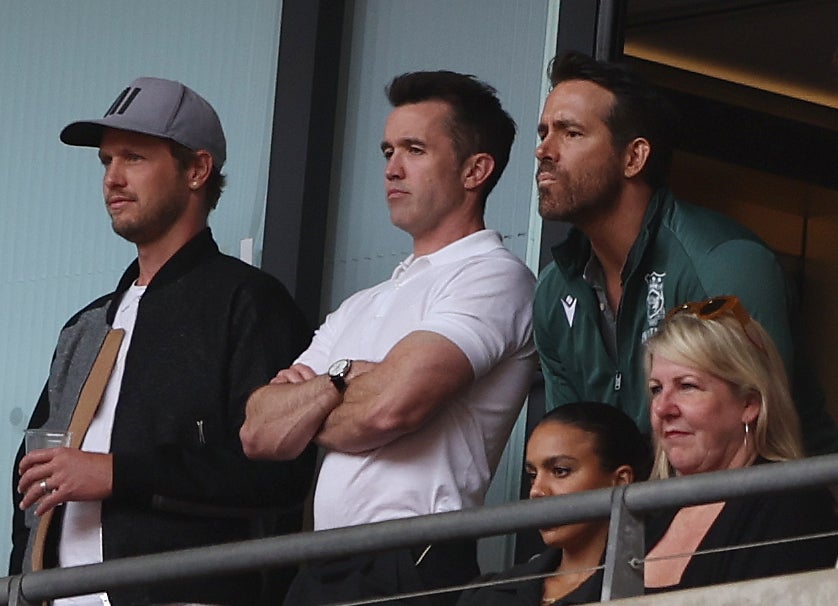 McElhenney (centre) and Reynolds (right) watch Wrexham FC play in May