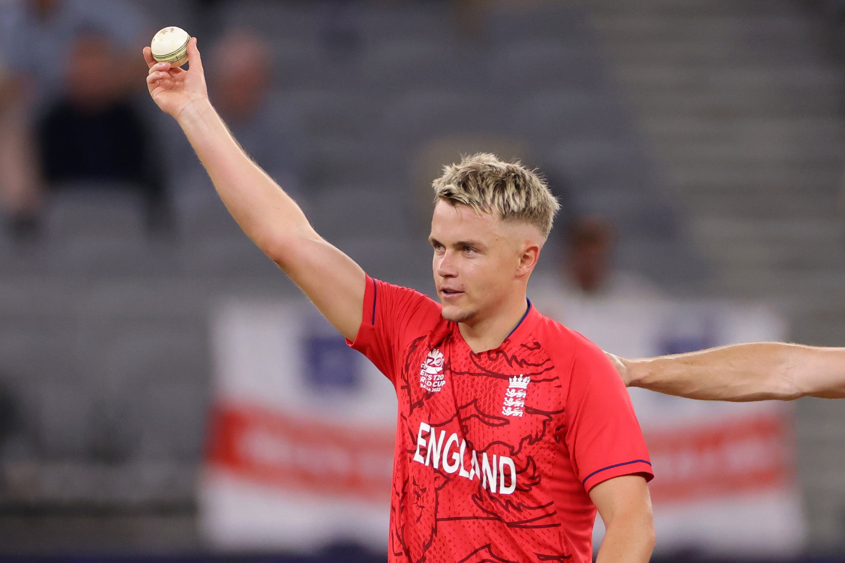 Sam Curran holds the ball aloft after taking five for 10 against Afghanistan in Perth (PA Wire/PA Images).