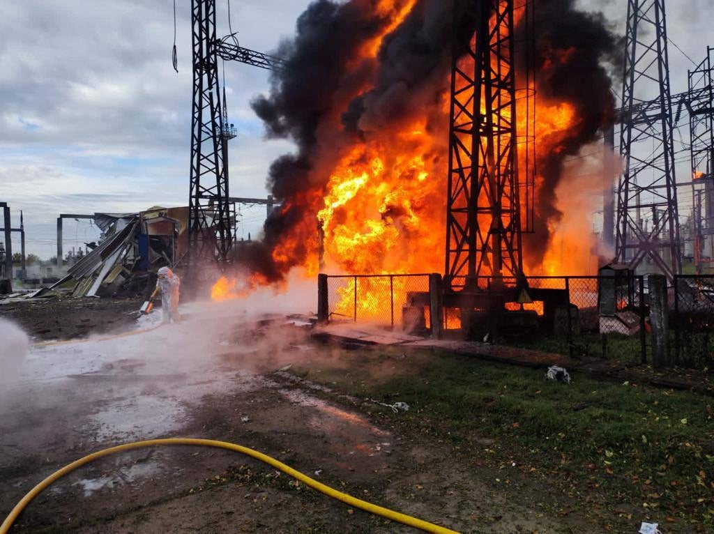 Firefighters try to put out a blaze at an undisclosed energy facility hit by Russian strikes