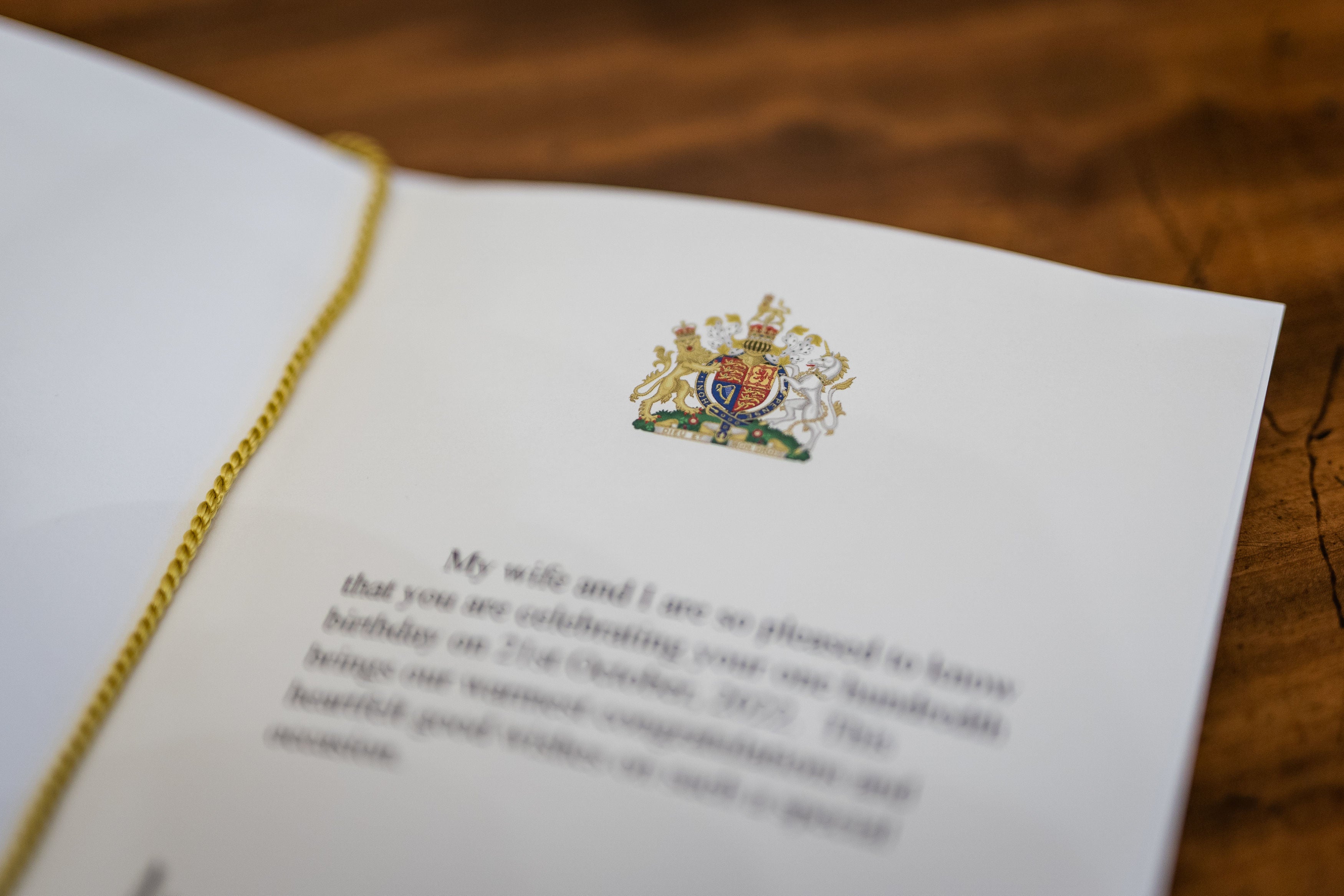 The message inside one of the first birthday cards celebrating 100 years of age, which have been signed by King Charles III and the Queen Consort at Buckingham Palace